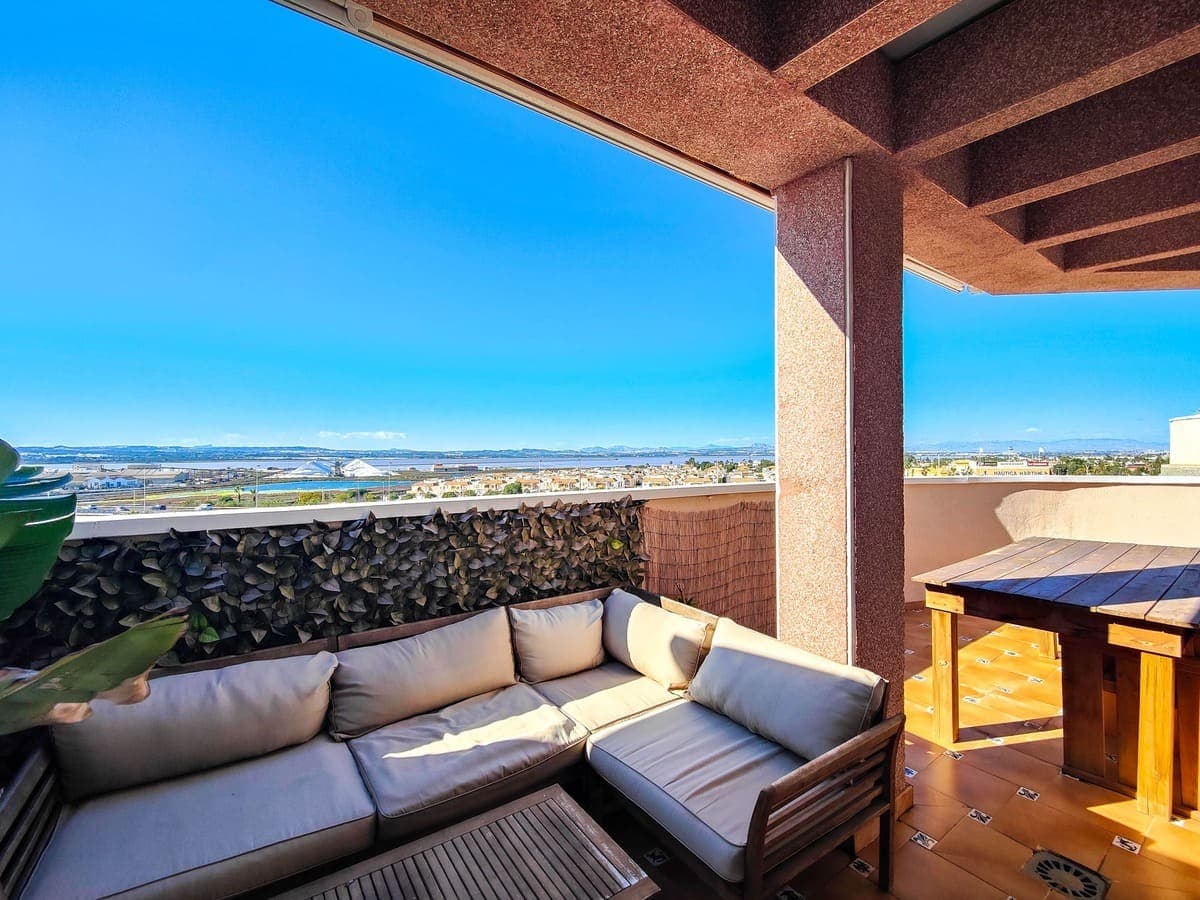 Penthouse for sale with a 40m2 corner terrace near the Parque de las Naciones in Torrevieja.The penthouse lies on the 5th and last floor in a building with an elevator. The penthouse has 3 bedrooms and 2 bathrooms, a modern fitted open plan kitchen with top brand appliances and a bright living room. The penthouse lies on a corner and has a large terrace of 40 square meters in the shape of an L to which all rooms have access. On the terrace there is a storage room and a storage cupboard. From this terrace you can enjoy a beautiful sunset over the salt lakes of Torrevieja. All three bedrooms are air-conditioned. The main room has a built-in wardrobe and an en-suite bathroom.The building lies close to all shops, several restaurants and bars, bus stop, pharmacy, banks etc... The beach and the promenade are within walking distance (1km). Parking is easy on the street (free) and there is also an area next to the building where you can park your car for free.