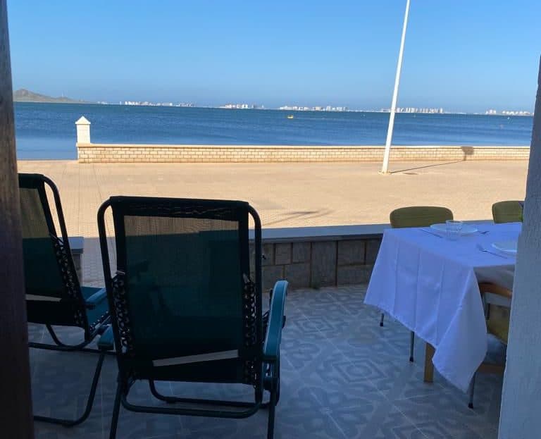 Discover the unique opportunity to acquire an exceptional beachfront duplex in Los Nietos, exempt from the Coastal Law.This dream property features four spacious bedrooms on the first floor and a full bathroom. It features a very bright living room. The fully furnished and renovated kitchen is functional and ready for use. It is being sold fully furnished and equipped.The focal point of this residence is its impressive terrace, offering direct panoramic views of the sea and the promenade. An ideal space for relaxation and enjoyment. The property is complemented by a practical garage. This duplex represents an unbeatable investment for those seeking a Mediterranean lifestyle without compromise. Don't miss this magnificent opportunity.