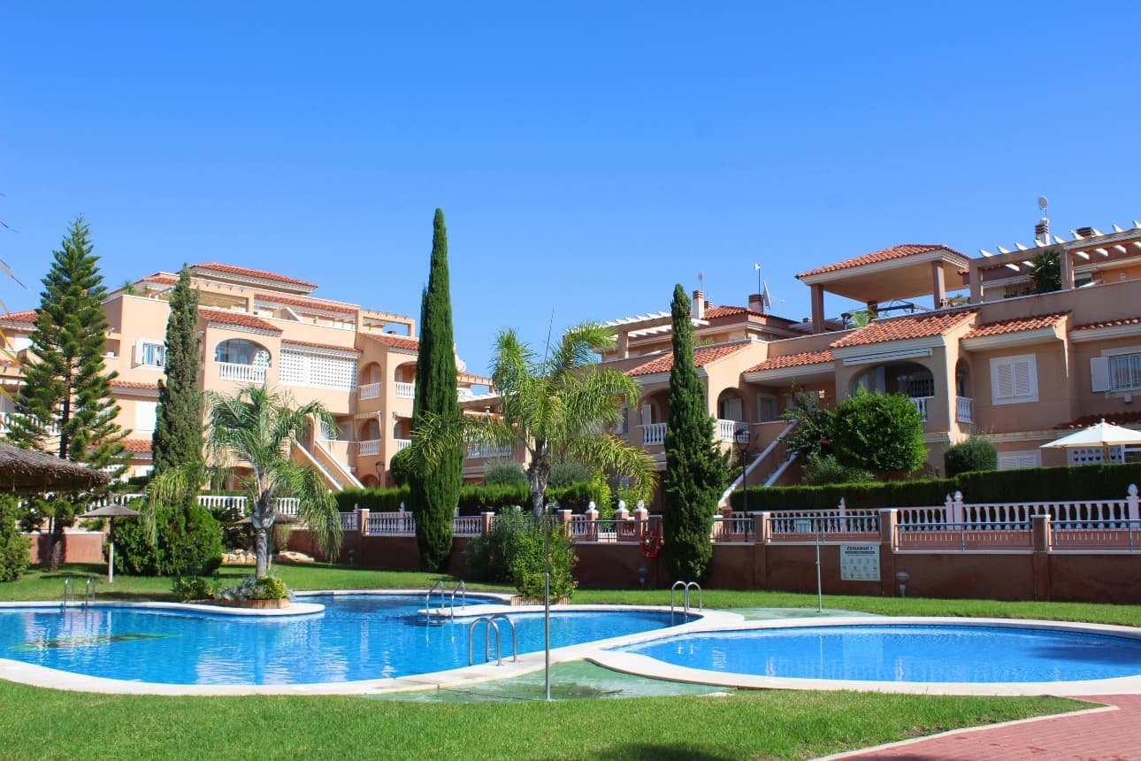 This beautifully presented, fully furnished south east top-floor apartment is perfectly situated in the highly sought-after Urbanisation Zeniamar in Playa Flamenca, offering breathtaking sea views and a superb Mediterranean lifestyle.The property features 2 spacious bedrooms, 2 bathroom both with shower, and a bright, open-plan living area, kitchen with a seperate utiliy area and access to a cosy glazed in terrace with sea view. From the main floor, an internal staircase leads to an upper level currently arranged as a home office or potential third bedroom, alongside a second bathroom and access to a large private rooftop solarium with a shower – the ideal place to enjoy the sunshine all day and take in the spectacular panoramic sea views. Additional features include:Fully furnished and move-in ready, fitted with Air conditioning, Underground parking and storage room (available at an additional cost 17.500.-€,) Beautifully maintained communal gardens, Large swimming pool, gym, and sauna within the community.Located in a prime central position, Zeniamar is one of the most desirable residential complexes on the Orihuela Costa, built by the renowned developer TM Group, known for its exceptional design and build quality. The complex is within walking distance to the Citrus Shopping Centre, with international supermarkets, cafés (including the Scandinavian supermarket), and just a 10-minute drive to La Zenia Boulevard, the largest shopping mall in Alicante province with over 150 shops, restaurants, and entertainment venues.The golden sandy beaches of Playa Flamenca are only 2 km away, offering crystal-clear waters and a range of coastal activities. The area is conveniently located 40 minutes from Alicante Airport, making it ideal as both a holiday home and a permanent residence.Whether you’re looking to relax in the sun, enjoy local cuisine, or explore the surrounding golf courses and coastline, this apartment provides the perfect combination of comfort, convenience, and stunning sea views. A true gem on the Orihuela Costa — a property not to be missed!