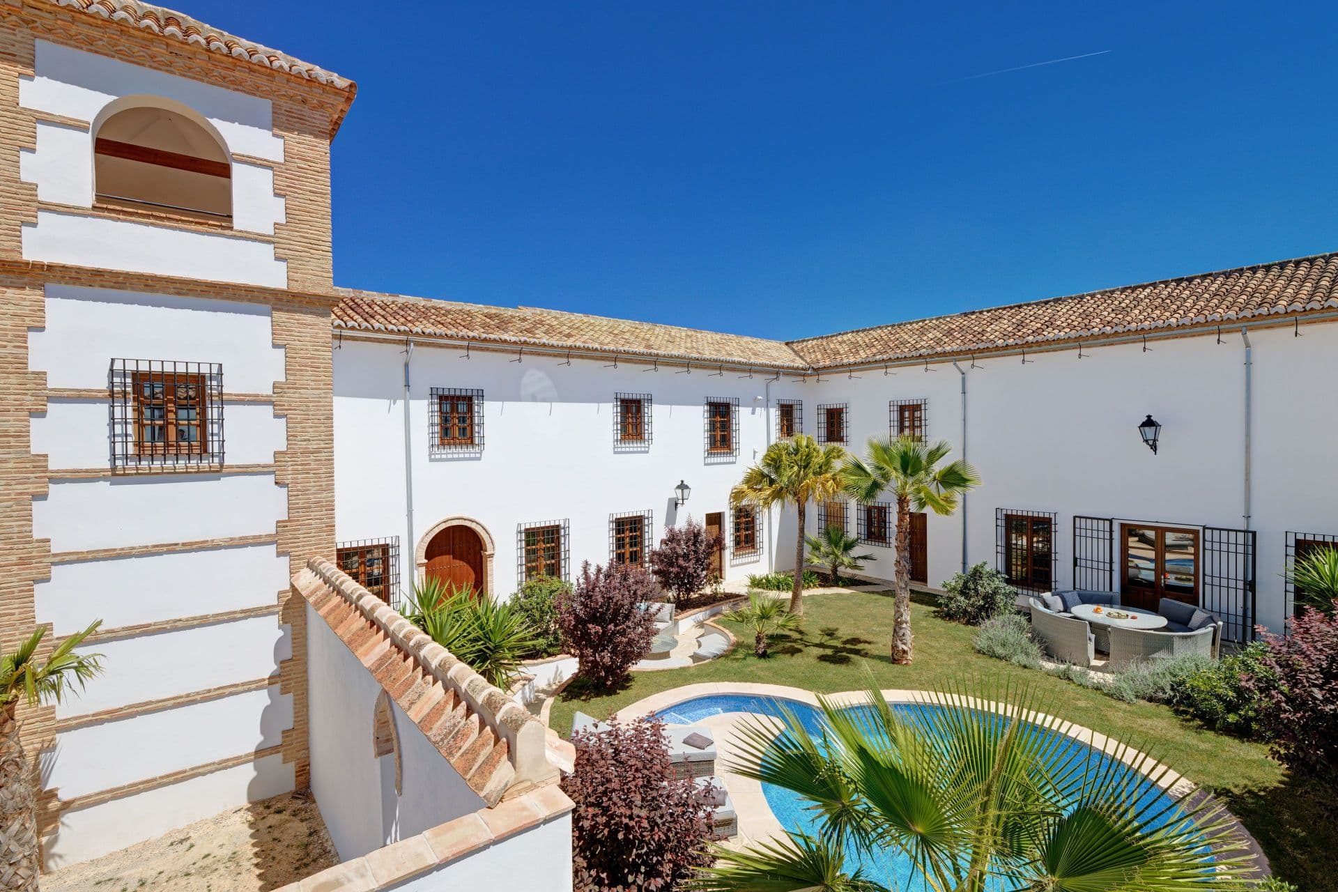 Discover the epitome of elegance and versatility with this extraordinary luxury cortijo and vineyard estate, a rare offering nestled in the scenic landscape near Antequera. Spanning 4 hectares of perfectly manicured, flat land adorned with flourishing vines, this estate combines opulence with opportunity, creating an exceptional lifestyle or investment venture. Located just 15 minutes from the vibrant town of Antequera, with its high-speed train connections, this property offers easy access to the best of Andalusia while maintaining ultimate privacy. The main house is nothing short of spectacular, arranged around a stunning central courtyard that exudes grandeur. With an impressive swimming pool, expansive gardens, and spacious terraces, every corner of this estate has been thoughtfully designed for luxury and relaxation. Enter the grand entrance hall, which flows effortlessly into a gourmet kitchen, formal dining hall, stately lounge, private study, and elegant cloakroom. Upstairs, four sumptuous bedrooms, each with their own en-suite bathrooms, provide an intimate retreat, with breathtaking views of the vineyard below. Every room is appointed with high-end finishes, blending traditional Andalusian charm with modern luxury. For additional convenience, the estate features separate guest accommodation, complete with its own fully equipped kitchen, lounge, bedroom, bathroom, and storage, offering a haven for guests or extended family. This could also be used as owner’s accommodation if the property is to be run as a business. This remarkable property offers limitless potential for both personal enjoyment and as a thriving business venture. Whether you envision transforming it into a luxurious bed and breakfast, an idyllic venue for wedding events, or a wine-tasting retreat, the opportunities are boundless. There’s also further development potential, there is an 80m2 undeveloped space that could be converted into a winery or three additional bedroom suites, allowing you to craft the estate into your dream vision. With its versatile layout, prime location, and potential for both relaxation and revenue, this cortijo and vineyard estate is truly a once-in-a-lifetime opportunity to own a luxurious sanctuary or create an extraordinary business in one of Spain's most beautiful regions.