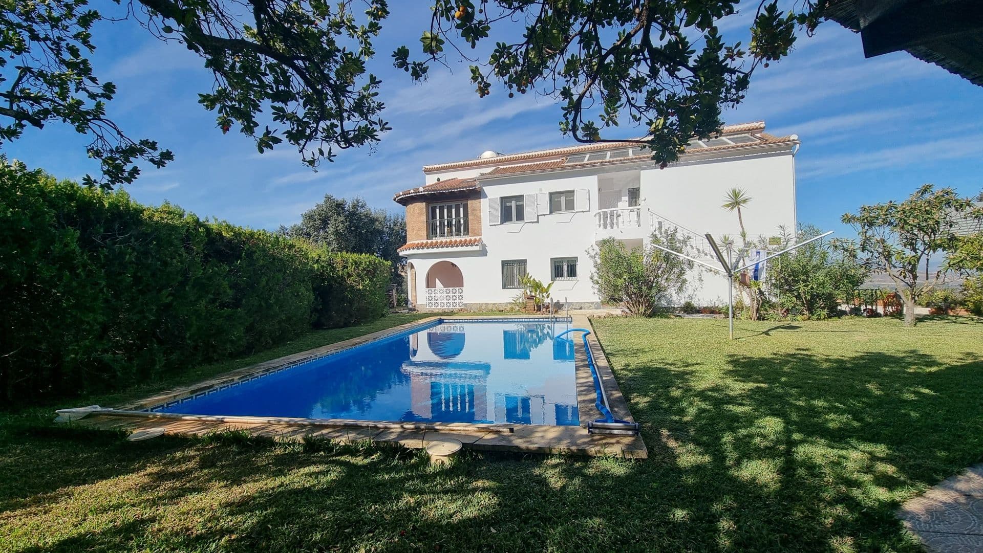 Country House with Panoramic Views in Alhaurín el Grande. This magnificent and solid country house built in 1991, is located in Alhaurín el Grande, and has a First Occupation Licence. This property, surrounded by exceptional natural beauty, combines tranquillity with convenience, being just a 10-minute drive from the town. It boasts spectacular 360º views and a south-facing orientation, maximising natural light. Property Features • PlotA fenced plot of 13,500m² featuring a wide variety of trees, including almond, olive, orange, holm oak, fig, loquat, avocado, and other fruit trees. Perfect for those seeking a connection to nature. • House LayoutThe property comprises two floors, each with an independent apartment: Ground floor:• 2 bedrooms. • Fully equipped kitchen. • Spacious living-dining room with a fireplace. • Private terrace.Top floor: • 3 bedrooms. • Kitchen and living-dining room with a similar layout to the ground floor. • Two covered terraces with stunning views. Construction Details• Double-glazed Climalit windows with aluminium shutters and mosquito screens. • Robust double-layer construction with fibreglass insulation, and insulated attic ceilings. Outdoor Spaces • Private heated pool with a heat exchange system. • Barbecue area. • Workshop, firewood storage, and machinery storage. • Independent 25m² storage room. Comfort and Technology • Air-conditioning and central heating via radiators, with a dual system: • Wood-fired boiler with a 2,500-litre storage tank. • Automatic gas boiler as a backup. • Fibre optic internet at 300Mbs and alarm system. • 300-litre hot water tank, heated by 16m² of solar panels or a gas boiler. • Heat exchanger pump for the pool, utilizing excess energy. Water Management • Private well that automatically fills a 16m³ tank for garden and fruit tree irrigation. • Automatic irrigation system for the lawn and vegetable garden, with a drip system for fruit trees. • Connection to the municipal water network with an additional 13m³ tank for property irrigation. Usage Options This house is perfect for: • Two families seeking independent living spaces. • Those looking for a property with rental potential, whether for vacation or long-term use. • Large families wanting to unify both floors into a single, functional family home. A unique opportunity to enjoy rural living with all modern amenities!