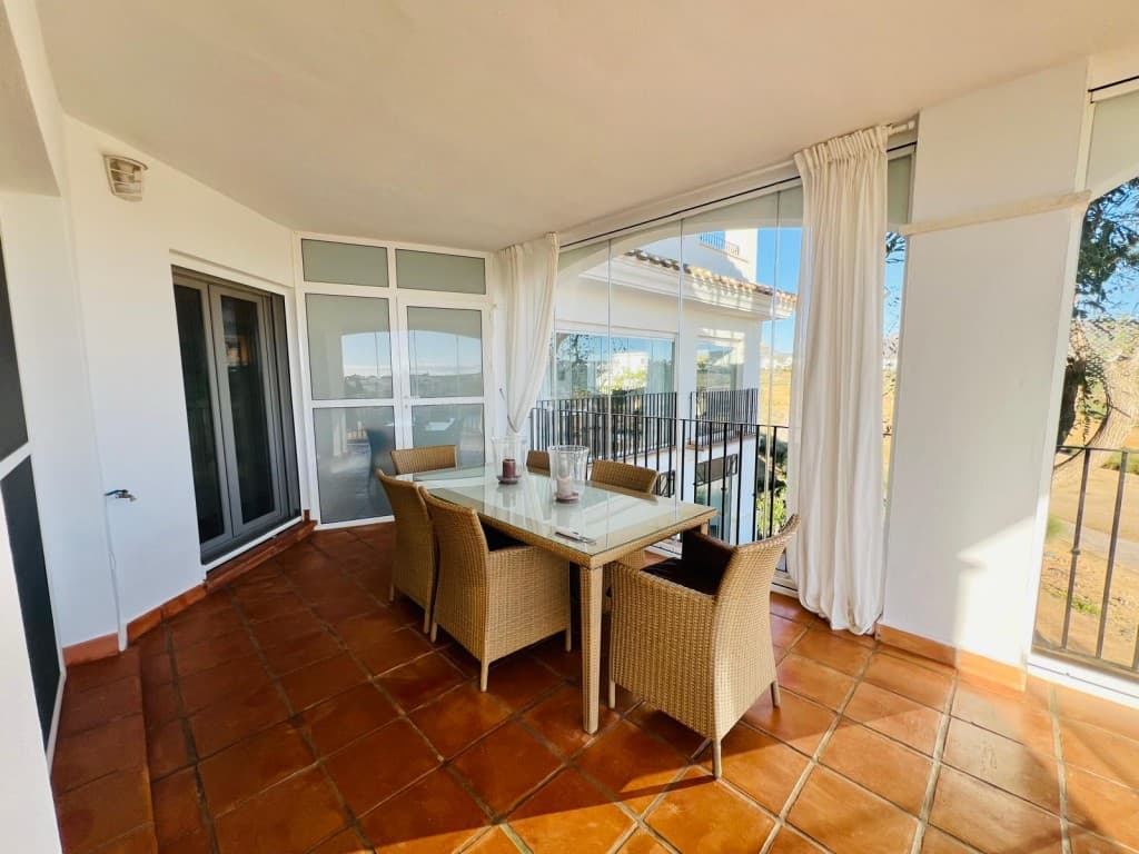 2 Bed 1 Bath Apartment . * PRICE REDUCTION MOTIVATED SELLER *We are delighted to present this highly sought-after 2-bedroom, 1-bathroom L-shaped terrace apartment, offering stunning views over the lake and golf course.The spacious living/dining area is enhanced by a newly installed air conditioning unit and large patio doors that open onto the expansive L-shaped terrace. This outdoor space is perfect for relaxing or enjoying alfresco dining, with breath-taking views as a backdrop. The terrace also features a remote-controlled awning with a wind sensor, ensuring comfort and convenience, along with an additional aluminium storage unit for added practicality.The well-appointed kitchen leads to a generously sized utility room, with all white goods included in the sale for ease of moving in.Both bedrooms are equipped with built-in wardrobes, and the master bedroom boasts direct access to the terrace, making it the ideal retreat.The bathroom is fitted with a bath and overhead shower, a stylish sink with vanity unit and mirror, as well as a WC and bidet, offering both comfort and practicality.Additionally, all windows throughout the property are fitted with mosquito nets, ensuring a peaceful and pest-free environment.For further convenience, the property includes a large private storage unit in the garage, as well as a designated underground parking space, accessible via a remote-control fob.This property is offered furnished, making it an excellent turnkey opportunity for buyers seeking a ready-to-move-in home.