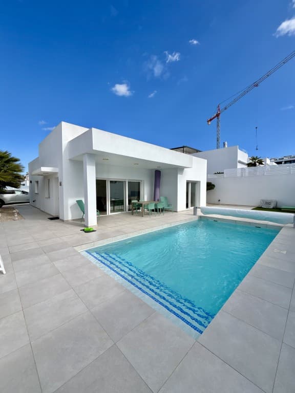 Beautiful modern detached villa on a corner lot in Benijofar. Located on a spacious corner plot of over 400 m², this beautiful modern villa offers a unique combination of privacy, openness, and comfort. Whether you are looking for a permanent home, a stylish vacation home, or a high-quality investment on the Costa Blanca, this property meets all expectations.From the very first moment, the sleek, modern architecture catches the eye. Large windows, minimalist lines, and a harmonious mix of high-quality materials create a light and elegant look.The property is designed entirely on one level, ensuring optimal living comfort and a seamless transition between indoor and outdoor spaces, ideal for those who love convenience and a modern Mediterranean lifestyle.Layout of the house3 spacious bedrooms with lots of natural light and built-in wardrobesA stylish master suite with direct access to the garden and pool2 modern bathrooms with high-quality finishes and a luxurious, spa-like feelA bright open-plan living room that maximizes space and lightA fully equipped modern kitchen with generous countertopsLarge sliding doors to the terrace for a perfect indoor-outdoor experienceThe living space forms the heart of the home and is perfect for both cozy family gatherings and relaxing evenings in peace and quiet.