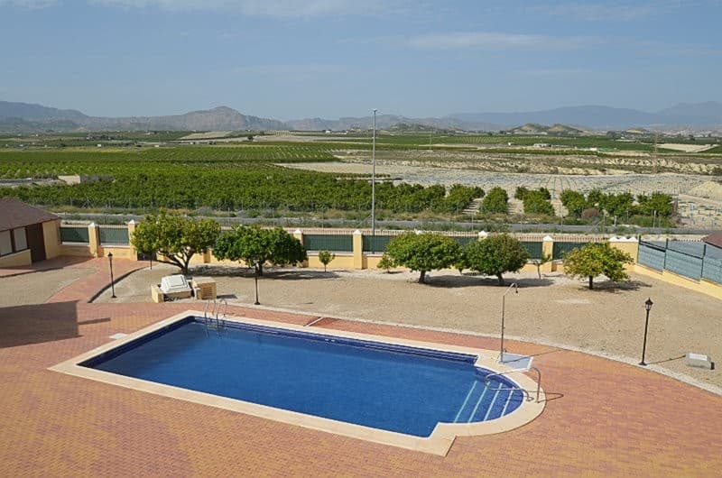Stunning 4-Bedroom 2.5 Bathroom Detached Villa with Spectacular Panoramic Views – Campos del Río, MurciaLocated in an elevated position in a highly sought after location in Campos del Río, this exceptional four-bedroom, 2.5 bathroom detached villa offers truly exceptional and uninterrupted views across the surrounding countryside and mountains with Murcia city in the distance.Approached via an impressive staircase spanning the full width of the front porch which is enclosed with stylish glass curtains, allowing for complete flexibility—fully open in summer or enclosed allowing year-round enjoyment. The property also benefits from convenient level access to the rear.Upon entering the property, you are welcomed into a spacious reception hall featuring an elegant wooden staircase leading to the first floor.The villa has tiled flooring throughout, providing both style and practicality.The hallway leads to a bright and airy dual-aspect lounge, with a feature fireplace and picturesque views over the swimming pool and surrounding landscape. French doors open onto the enclosed terrace, creating an ideal indoor-outdoor living space.The well-appointed kitchen is fitted with appliances including oven, hob, extractor, dishwasher, and fridge freezer, complimented by sleek granite worktops. From here, you can enjoy views over the rear garden, with direct access to a terrace featuring a charming gazebo, perfect for al fresco dining. A separate larder provides additional storage and houses a further fridge freezer.The staircase leads to the landing with a door that opens onto a wraparound terrace, offering 360º vantage points to take in the breathtaking scenery.The remainder of the first floor is dedicated to the master suite which is a standout feature of this property, with direct terrace access, a generous dressing area with floor-to-ceiling wardrobes, and a luxurious en-suite bathroom complete with a corner bath, separate shower with contemporary glass blocks, twin basins, bidet, and WC.The ground floor offers three well-proportioned bedrooms and a stylish family bathroom featuring both bath and separate shower, twin basins, bidet, and WC. There is a convenient separate cloakroom with WC and pedestal basin.Externally, the villa continues to impress. There is an outdoor kitchen with a brick-built barbecue providing excellent entertaining facilities. This houses the washing machine and a hot water heater. In addition, there is a separate shower room with WC and basin and two further storage areas. This building could easily be converted into an independent casita.A beautifully designed summer room, also enclosed with glass curtains, houses a hot tub (currently not operational) and dining area - an idyllic space to relax while taking in the spectacular surroundings. Just steps away lies a large, inviting saltwater swimming pool (10 x 5), perfect for enjoying the Mediterranean climate.The property is set on a generous plot with external lighting and a number of fruit trees and further benefits from a substantial double garage with a remote-controlled up-and-over door.This is a rare opportunity to acquire a beautifully presented villa in an enviable position, combining space, privacy, and truly outstanding views.Car journey times are as follows:Village 5 minutesAirport - Murcia International 30 minutesAirport - Alicante International 55 minutesBeaches 50 minutesHospital 20 minutesMurcia City 25 minutesShopping Centres - Nueva Condomina and Thader 30 minutes