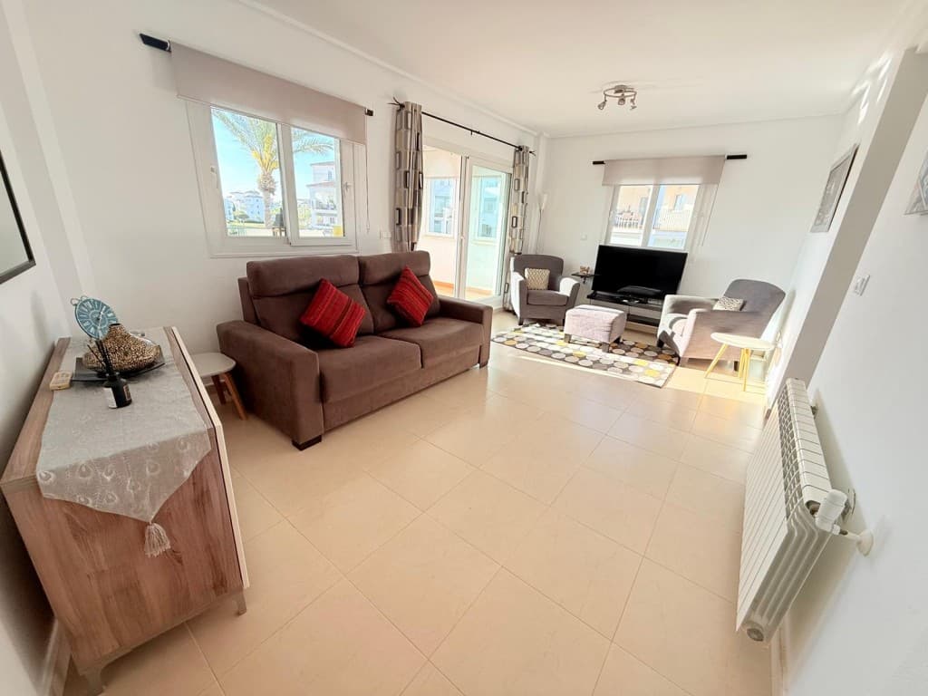 Stunning End Apartment with Panoramic Golf, Lake & Pool Views – Hacienda Riquelme Golf ResortThis beautiful end-position apartment is perfectly situated on the sought-after Hacienda Riquelme Golf Resort, offering breathtaking views over the golf course, lake, and communal pool. With its sunny orientation and additional side window, the property is filled with natural light throughout.The spacious lounge and dining area is bright and welcoming, furnished in a modern style and equipped with air conditioning and radiators for year-round comfort. Large patio doors open onto a stunning terrace featuring glass curtains and two elegant arched windows that fully open, allowing you to truly enjoy the spectacular surroundings.A hallway leads to a fully fitted contemporary kitchen, complete with all white goods and a window overlooking the beautifully maintained communal gardens.The generously sized bathroom includes a bath with overhead shower and screen, WC, vanity unit with basin, mirror, washing machine, towel rail, and a window for natural ventilation.Both bedrooms are well-proportioned and feature fitted sliding wardrobes, ceiling fan lights, radiators, and French doors opening onto Juliet balconies with views across the gardens and mountains.Additional benefits include secure underground parking with remote access and a private storage unit.The resort itself offers 24-hour security, an on-site restaurant, supermarket, and coffee shop. It is ideally located just a 5-minute drive from the charming town of Sucina, where you’ll find a wide range of amenities, bars, and restaurants. The property also provides an excellent base for exploring the wider Costa Cálida region, including the historic cities of Cartagena and Murcia.For further information or to arrange a viewing, please contact our friendly team, all of whom live and work on the resort.