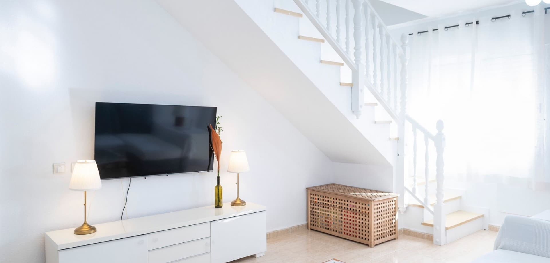 Located in the charming coastal town of Santiago de la Ribera, this bright and spacious triplex offers the perfect combination of space, privacy, and Mediterranean lifestyle — just a short walk from the beach and close to all amenities. Spread across three levels, the home offers generous living areas designed for both everyday comfort and relaxed holiday living. The property features four bedrooms and two bathrooms, making it ideal for families, visiting guests, or those looking for extra space for remote work or hobbies. The main living area is bright and welcoming, with a spacious lounge and a separate fully equipped kitchen, complemented by a practical laundry area. Large windows and the excellent south orientation allow natural light to flow throughout the home, creating a warm and inviting atmosphere all year round. Outside, the property truly embraces Mediterranean living. Both the front and rear patios provide comfortable outdoor areas, including artificial grass spaces that are perfect for relaxing, entertaining guests, or enjoying long sunny afternoons. A private swimming pool adds an extra level of comfort and exclusivity — ideal for cooling off during the warm Spanish summers.The property also includes a private garage space and air conditioning in the main living areas, ensuring comfort in every season. Situated in a quiet residential area yet within easy reach of shops, restaurants, and the popular Dos Mares shopping centre, this home is perfectly positioned for both permanent living and holiday use. The beach is only a short distance away, allowing you to fully enjoy the relaxed lifestyle of the Mar Menor coastline. This property is an excellent opportunity whether you are looking for a spacious family home, a sunny holiday retreat, or a smart investment on the Costa Cálida.