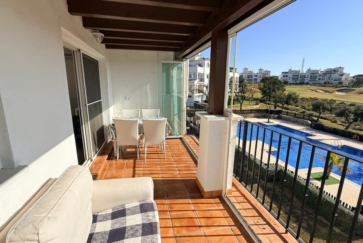 Experience the perfect blend of modern elegance and Mediterranean charm in this stunning 2-bedroom, 1-bathroom apartment. Located within the prestigious Hacienda Riquelme Golf Resort, this property features the highly sought-after curved wall design, offering a unique architectural flair and a spacious, flowy feel.Modern Living & Refurbished EleganceStep inside to a home that has been thoughtfully updated for contemporary comfort:Gourmet Kitchen: A large, fully refurbished modern kitchen equipped with sleek finishes—perfect for the home chef.Designer Bathroom: A bright, smart, and fully renovated bathroom featuring a spacious walk-in shower.South-Facing Aspect: Enjoy maximum sunshine throughout the day across the entire living space.Stylish Interiors: The apartment comes beautifully appointed with modern furnishings, allowing you to move straight in or start renting immediately.Outdoor Spaces with a ViewThis property boasts two distinct outdoor areas, offering the best of both worlds:The Main Terrace: A large, sun-soaked space perfect for alfresco dining or lounging. It offers sweeping views of the manicured golf greens and the inviting communal swimming pool.The Mountain-View Patio: Both bedrooms are designed with simplicity and light in mind. Each features French doors that open onto a second private patio, where you can wake up to breathtaking panoramic views of the mountains.A Prime LocationSituated in a fantastic hub for explorers and sun-seekers alike, you are perfectly positioned to enjoy the best of the region:20 Minutes to the golden sands of local Mediterranean beaches.20 Minutes to the vibrant culture and shopping of Murcia City.20 Minutes to Murcia International Airport, making travel effortless.Whether you are looking for a high-end holiday retreat, a savvy investment property, or a permanent slice of paradise, this Hacienda Riquelme gem is a must-see.Contact us today to schedule a viewing and see the views for yourself!