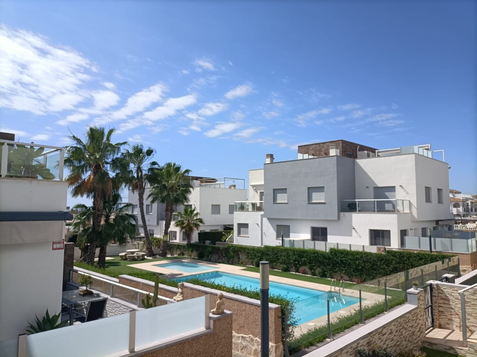 Welcome to this stylish and beautifully maintained ground floor apartment in the sought-after area of Punta Prima – offering the perfect blend of comfort, convenience, and Mediterranean lifestyle.

This bright apartment features an open-plan layout with a fully equipped kitchen and spacious living room, flowing seamlessly through large glass doors onto a sunny terrace with direct access to the lush communal garden and inviting pool area. Whether you're enjoying breakfast in the morning sun or relaxing with a glass of wine in the evening sun, this apartment has the ideal outdoor setup – with not one, but two private terraces to choose between, front and back, so you can enjoy sun or shade throughout the day.

There are two generously sized bedrooms with fitted wardrobes and two fully tiled bathrooms with underfloor heating – one of them en suite. The apartment is in excellent condition and comes fully furnished – ready for you to move in and start enjoying the good life.

Located in a secure, gated community of just 34 apartments, the property also includes a private parking space inside the complex with an automatic gate. Additional features include air conditioning, electric blinds, a reinforced security door, and a ground-level patio with direct garden access.

The location is unbeatable – within walking distance to restaurants, shops, schools, playgrounds and public transport. The beach is just 1.5 km away, La Zenia Boulevard only 3 km, and Alicante Airport is a comfortable 45-minute drive.

Punta Prima is a vibrant coastal area known for its beautiful beaches, excellent restaurants, and relaxed Mediterranean lifestyle. Just minutes from golf courses, shopping centres, and all essential services, it offers the perfect blend of comfort, convenience, and seaside charm – ideal for both permanent living and holiday escapes.

We asked the owner what they think is the best about the apartment and received following answers:

"Bright, open & spacious homeUnderfloor heating in the shower roomsLarge social areas in the kitchen and living roomWalking distance to shops, bars, restaurants, etcSmall quiet urbanization, 32 owners, with good neighborsFantastically helpful presidentHigh securityGood economy in the urbanization"