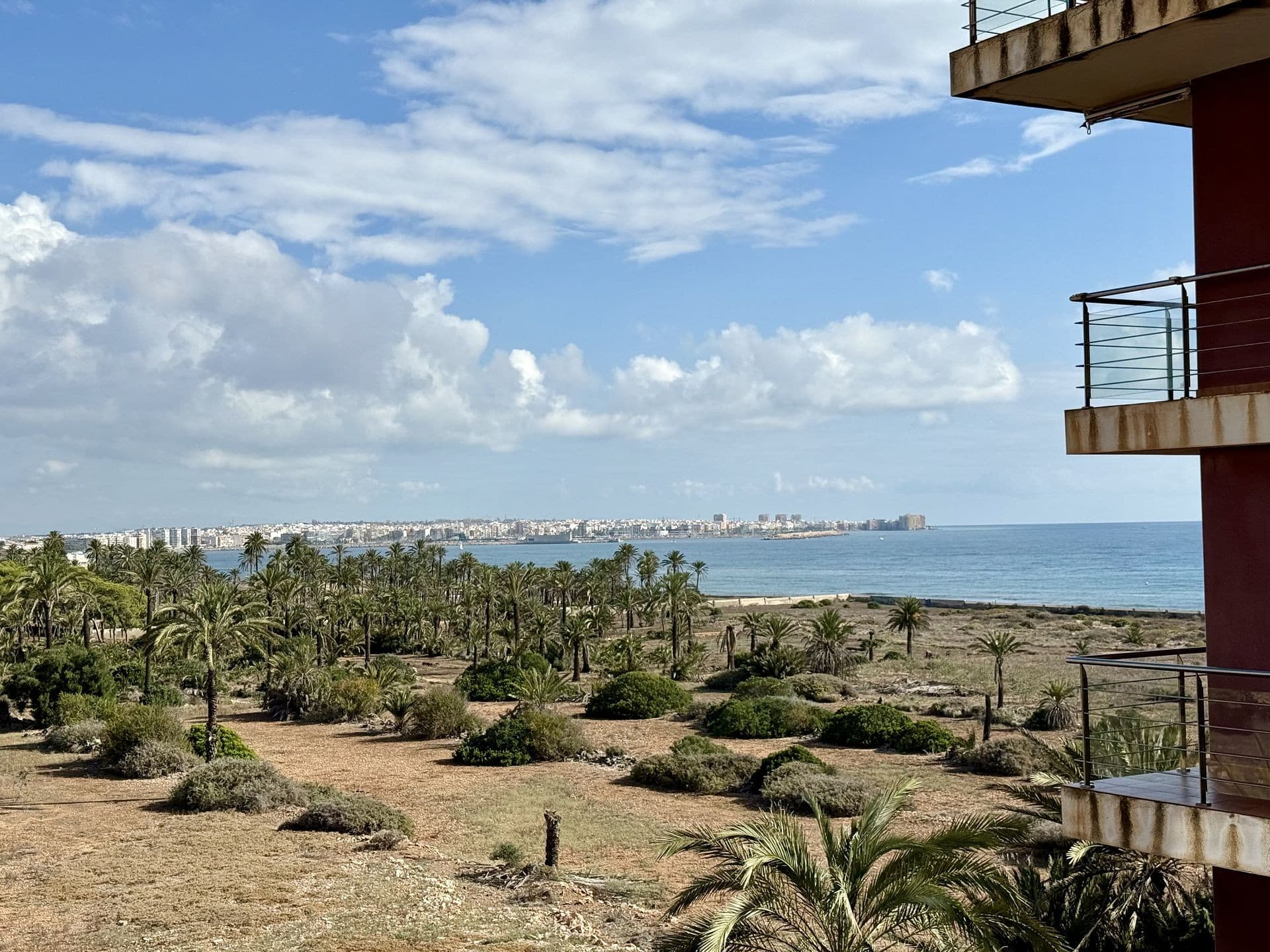 . Bright and Cozy sea view Apartment 300 m from the Beach with private swimming pool, central air conditioning, and tourist licence in Punta Prima, Torrevieja, Alicante. Welcome to your perfect holiday retreat on the sunny Costa Blanca!  Just a short stroll from the sea in peaceful Punta Prima, this modern two-bedroom apartment offers comfort, style, and everything you need for a relaxing getaway.This bright third-floor home, with elevator access, includes:Living room with sofa, smart TV, and private balcony — perfect for morning coffee or sunset drinks.Open-plan kitchen fully equipped with stove, oven, microwave, washing machine, fridge, coffee maker & toasterBedroom with a comfortable double bed, fresh linens, bedside lighting, and ample storageBathroom with full bathtub, bidet, vanity, towels, toiletries & hairdryerModern comforts: Air conditioning, high-speed Wi-Fi, and all essentials for a home-away-from-homeAmenities & ExtrasJust a few minutes’ walk to the beachBeautiful communal pool with sun loungers & outdoor shower.Underground parking is included in the price.Secure building with gated entrance.Ideal for couples or small families.Location – Punta Prima, Torrevieja.Safe, quiet, and family-friendly neighborhood.Walking distance to supermarkets, cafes, restaurants, and shopsEasy public transport connections and short drives to top attractionsClose to La Zenia Boulevard, nature parks, and golf coursesWhether you’re here for sun, sea, or relaxation, this Punta Prima apartment is your perfect base on the Costa Blanca! 