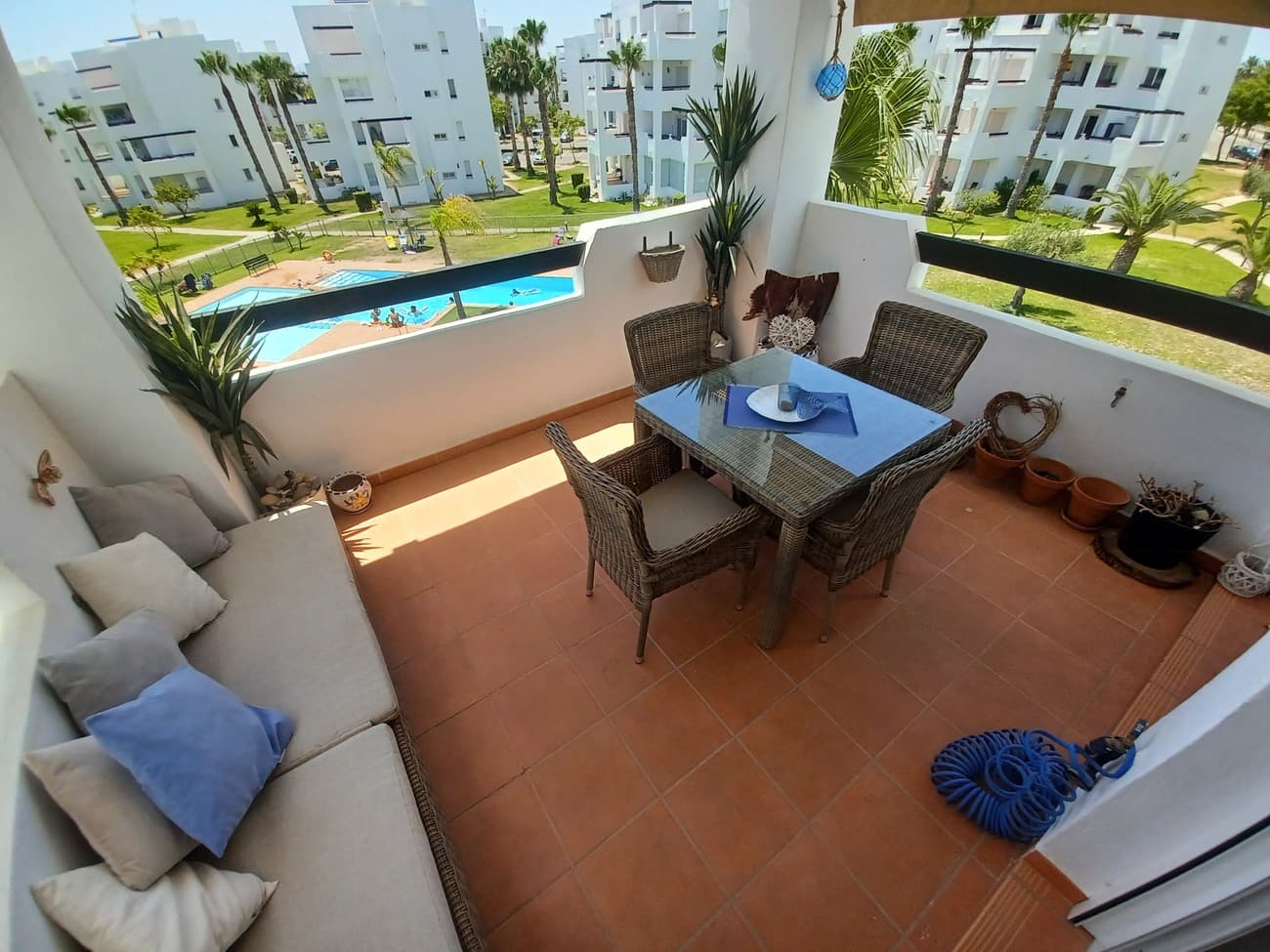 This beautiful apartment in Terrazas de la Torre Golf Resort is light, bright and airy with a terrace overlooking gardens and swimming pool.  The apartment enters into an open plan living room and kitchen; the living area is the ideal place to relax on the sofa with airconditioning, satellite TV and WIFI included with views to the terrace and to the gardens.  The kitchen is open plan with new water boiler, washing machine, dishwasher, ceramic hob, oven and extractor.  The living room leads to a spacious covered terrace, it is South facing to enjoy plenty of sunhine and views over the garden, swimming pool and golf course; the terrace has space to relax and enjoy outdoor dining. There is a hallway off the living room leading to 2 bedrooms & the bathroom, the main double bedroom has patio doors with direct access to the terrace, it comes with fitted wardrobes.  The second bedroom is a smaller double, with views over the gardens, it also comes with fitted wardrobes.  The bathroom has a bath, a wc, a wash hand basin and bidet.  The apartment is to be sold part furnished including all fittings.  This apartment is situated on the second floor, there is a lift from the ground floor directly to the apartment and also to a communal terrace on the 3rd floor; the communal terrace is very expansive and offers beautiful views to the sea; this communal terrace can be used by all owners in the building; there are plenty of marked parking spaces outside the apartment block.  This apartment is situated very close to the security gate where 24 hour security team are based and it is also just a short walk to the town centre with supermarket, clubhouse and ´The 19th Hole´ bar & restaurant where there is great food and entertainment.  Golf resort living offers beautiful walks and gardens; it is safe and very well maintained.  Situated just 20 minutes from the coast with great beaches and facilities and 20 minutes to Corvera Airport and 1 hour to Alicante airport, this apartment is the ideal place to relax and enjoy quality living.