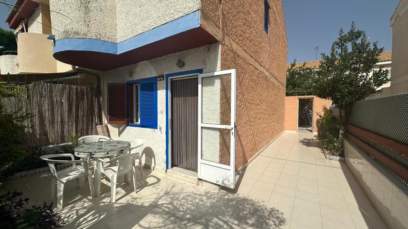 This two-story duplex offers a rare opportunity to create your dream coastal home in one of Santiago de la Ribera’s most sought-after locations. Just 450 metres from the beach and a short walk to the popular Dos Mares shopping centre, you’ll have the sea, shops, cafés, and restaurants right at your doorstep.Currently in need of renovation, this property is a perfect fixer-upper for those looking to add value and personal style. With 70.99 m² built on a 100 m² plot, it features:Ground floor : living room, sitting area, and kitchen.Upper floor : two bedrooms, one bathroom, and a terrace.Outdoor space: 28 m² open patio + 35 m² garden – ideal for relaxing or entertaining.Whether you envision a stylish modern beach house or a charming Mediterranean retreat, this home has the space, location, and potential to become something truly special.Prime location: 450m to the beach, close to Dos Mares, with easy access to services, transport, and leisure options.Investment potential: renovate to your taste and enjoy an enviable coastal lifestyle or strong rental returns.
