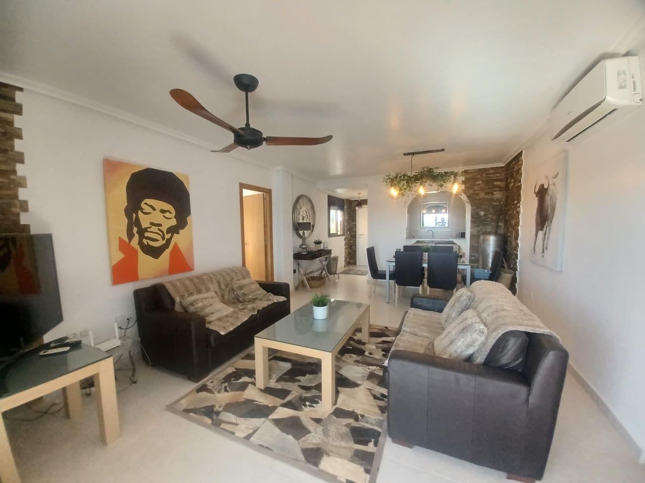 This unique apartment offers spacious living, large wrap around covered terrace with panoramic views across the traditional village of Sucina, the countryside and the sea.  The apartment enters into a hallway leading to a spacious living room with open plan kitchen to the left.  The living/dining room has plenty of natural light, it is  tastefully furnished with leather sofas, dining table and chairs, tasteful units, light fittings and ceiling fans with patio doors leading to the terrace to enjoy the stunning views.  The kitchen is fully fitted with granite worktop, ceramic hob, oven, extractor, fridge freezer and washing machine and a granite bar with stools leading to the living/dining area.  The living room leads to the right to the first double bedroom; it is a double bedroom with double bed, bedside tables and fitted wardrobes.  To the left in the living room is a bathroom with shower, wc and wash basin; tiled from floor to ceiling with quality white and neutral tones.  The second bedroom is the the left, a double bedroom with patio doors and direct access to the terrace to enjoy the morning sun this bedroom comes with bed, bedside table and fitted wardrobes.  The third bedroom is the master bedroom with en suite bathroom; this bedroom is large with double bed, bedside tables, ceiling fan, patio doors to lead to the terrace to enjoy sunshine all day long.  The en suite bathroom comes with a bath/shower, double sink vanity unit, spotlight mirror, wc and bidet tiled from floor to ceiling in neutral ceramics. The terrace is stunning, it is a large L shaped terrace with different areas, ideal to find sunshine or shade and can offer dining and lounge areas with quality wicker sofa, armchairs, 2 matching wicker sunbeds and 2 hanging string chairs to relax and enjoy the stunning views.  Set in the La Vereda building in an elevated position at the top of the village the building comes with granite floors in the entrance hall,  lift, communal pool and communal terraces.  Situated in the traditional village of Sucina with supermarkets, restaurants, bars, medical centre and pharmacy nearby it is an ideal place for all the family.  Sucina has live music at the church square every weekend all summer long to enjoy yet this building is a 5 minute walk to the main Square and it is in a quiet position.  Sucina offers a great quality of life and community; just 20 minutes drive to the coast with great beaches, 25 minutes drive to the city of Murcia and 20 minutes drive to the airport.  This apartment comes fully furnished as seen and is highly recommended for viewing.