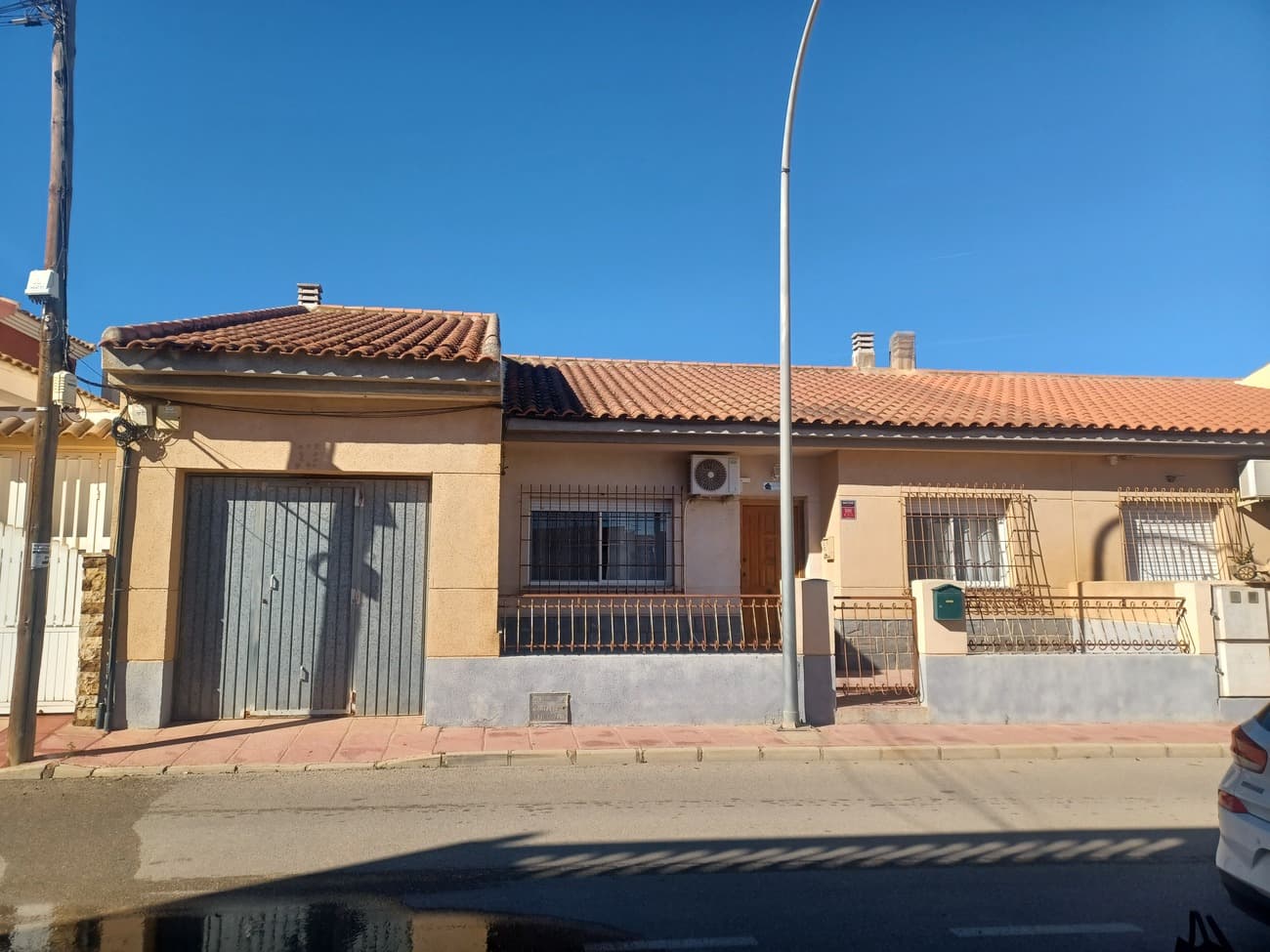 This beautiful house on a quiet residential street in the traditional Spanish village of Roldan offers spacious living on one level within short walk to all amenities.  The house enters into a terraced front garden space, ideal for enjoying the morning sunshine.  The house enters into a hallway which leads to all of the rooms, to the left is the living room; it is a large spacious room with plenty of natural light furnished tastefully with 2 cream sofas, wooden round dining table and chairs, storage units and TV unit.  To the right of the hallway are the bedrooms, the first is a large double room featuring wooden wardrobes, double bed, dressing table and window to the front of the house.  The next room to the right is a large bathroom, remodeled to a high standard with white and wood coloured tiling finish, a walk in shower, wc and vanity unit.  The hallway turns and the next room on the right is the second bedroom, a double room with double bed, drawer unit and wardrobe unit with window overlooking the rear courtyard.  The third double bedroom is painted green with a double bedroom, pine coloured drawer unit and wardrobe and window overlooking the courtyard. The fourth bedroom is a double, currently with wardrobe units and drawer units.  The end of the corridor leads to the kitchen, a fully fitted kitchen with while units, granite worktop, fully tiled the kitchen comes fully equipt with fridge, freezer, oven, gas hob, and extractor; the kitchen has 2 more doors;the door to the left leads to another small hallway with a bathroom with shower, wc and vanity unit, this hallway leads to another door to the living room and a door to the garage allowing direct access from the car to the house.  The door to the right from the kitchen leads to a unity area with sink and boiler leading to a back garden/court-yard area; this area is ideal for outside dining with total privacy and is west facing for evening sun.  There is a storage room, a BBQ and space for a pool in this area.  This home comes fully furnished as seen an offers very comfortable living within a short walk to great restaurants, with golf courses nearby, just 20 minutes drive to the airport and the coast.  Highly recommended for viewing.    