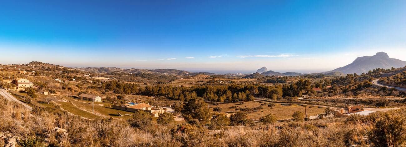 An exceptional retreat of timeless elegance, this historic finca was originally built in 1900 and underwent a meticulous renovation in 2006, where its authentic soul was preserved while refined comforts were introduced. Enveloped by more than 25,000 m² of private land, it offers a sanctuary of beauty, tranquillity, and absolute privacy.The main residence unfolds across two levels, designed with both sophistication and warmth in mind. The ground floor welcomes you with expansive living rooms, a chef’s kitchen, a charming dining area, and three generous double bedrooms complemented by two stylish bathrooms. On the upper floor, three additional suites—each with a private en-suite bathroom—create a haven of luxury for family and guests.Two fully independent guest residences enhance the estate, each featuring an intimate lounge with open kitchen, a double bedroom, and a private en-suite bathroom. These spaces are perfect for hosting guests in style or offering bespoke rental opportunities.A versatile multi-purpose pavilion allows endless possibilities, from a private gym to an art studio or workshop. Outdoors, a magnificent pool is embraced by sun-drenched and shaded terraces, creating an idyllic setting for entertaining, dining al fresco, or simply immersing yourself in the serene Mediterranean lifestyle.Adding to its exclusivity, the finca benefits from a DIC (Declaración de Interés Comunitario), permitting business activities under licence—making this estate not only an extraordinary residence but also a rare investment opportunity.This is more than a home; it is a statement of prestige, privacy, and timeless beauty.