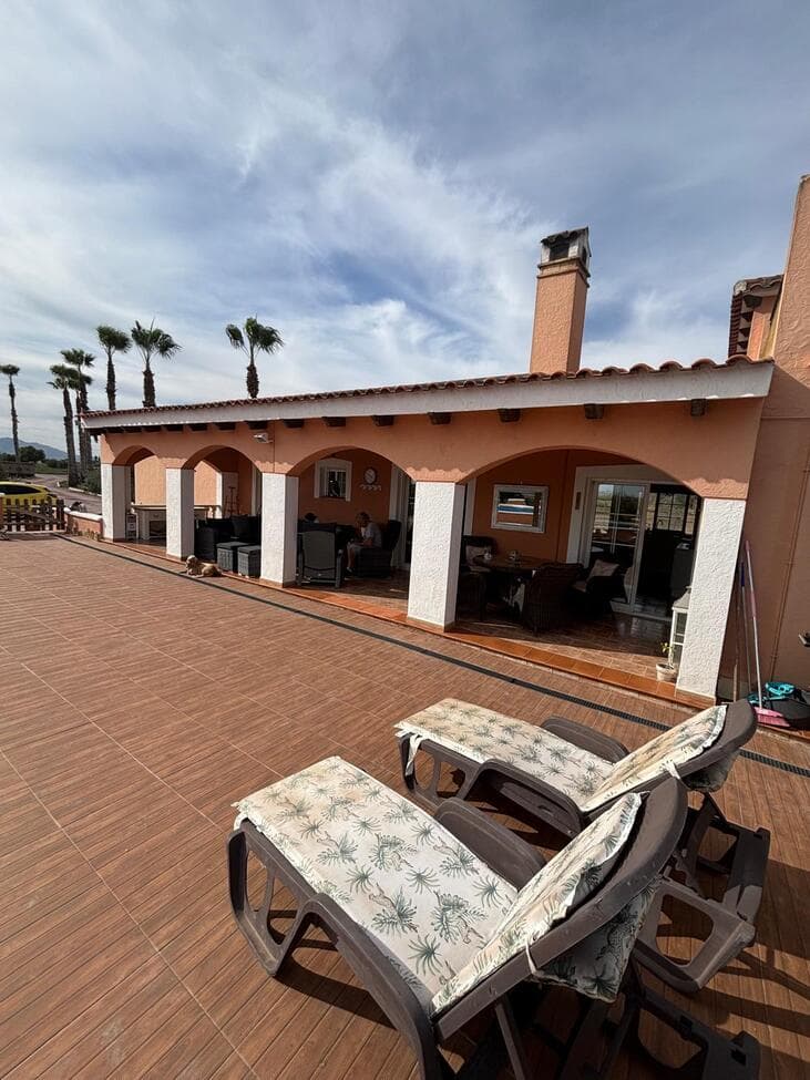 Stunning Country Villa with Breathtaking Mountain Views & Private PoolThis beautiful and spacious villa offers exceptional countryside living, featuring three double bedrooms (with potential to create a fourth), vaulted ceilings, and a modern kitchen complete with exposed beams and a stylish central island. The home enjoys a dual-aspect layout, flooding the interior with natural light and offering magnificent mountain and pool views.Fully equipped for comfort and efficiency, the property includes air conditioning , solar energy with lithium battery storage, and an Electric Vehicle charging point powered by the system. Mains water is also connected.The main bedroom suite features patio doors leading directly to the naya  and pool area, a huge walk-in wardrobe, and a luxurious ensuite bathroom with a bath and overhead shower. The villa’s bright and airy living spaces include a large lounge with patio doors opening onto the rear terrace decking —perfect for enjoying the sunsets and stunning mountain backdrop.Additional features include a spacious utility/food prep room and a converted garage, currently used as a living room and small office but easily adaptable as a fourth bedroom.Outside, the covered naya opens onto a raised pool area with ample sunbathing space, all surrounded by fenced land and open farmland views. The property also benefits from a roof solarium offering 360° panoramic views of the surrounding countryside.The land is fully enclosed and comes complete with a tractor ride on lawnmower , ideal for those wishing to cultivate the land, keep horses, or even explore opportunities such as a motorhome park.This is a truly versatile property offering space, sustainability, and spectacular scenery — perfect for those seeking peace, privacy, and potential in the heart of nature. 