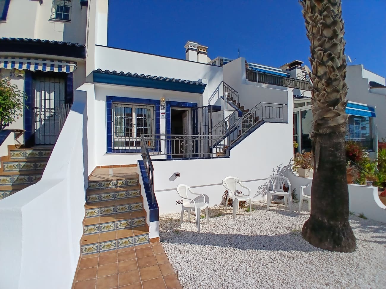 Beautiful semi-detached bungalow located in Orihuela Costa, Villamartín, in the Los Dolses area, Residencial Rioja V. A well-established area, just a 10-minute drive from the beaches of La Zenia or Cabo Roig. Surrounded by three prestigious golf courses (Villamartín, Las Ramblas, Campoamor). The area is notable for its proximity to the La Rioja Shopping Center (which includes a Dialprix supermarket and restaurants), the Villamartín Plaza Shopping Center, and the Zenia Boulevard Shopping Center. Excellent connection to the N332 road and the AP-7 motorway, facilitating access to Alicante (45 min) and Murcia airports.• Description: Semi-detached bungalow on two floors with private front and rear gardens and a solarium on the upper floor. Renovated and fully furnished. Ready to move in. It features a living-dining room with a fireplace, a kitchen with a breakfast bar and brand-new cabinetry (upper and lower cabinets, granite countertop, stainless steel extractor hood, ceramic hob, oven, and electric water heater), a full bathroom, and two large bedrooms, both with built-in wardrobes. The upper floor, accessed by an external staircase, has a 36.67 m² solarium, part of which is covered, with lighting and a water connection. It has split-system air conditioning in the living room, ceiling fans in the bedrooms. A hot water tank can be found in the utility room and a Natural Gas supply is available but not currently connected.The complex features well-maintained communal gardens and two communal swimming pool areas.Contact our team now for soonest viewing!