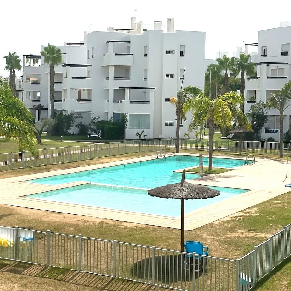 One-Bedroom Apartment in Las Terrazas de la Torre Golf, Murcia – Newly Renovated, South-Facing with Pool Views.This beautifully renovated one-bedroom apartment is located in the desirable Las Terrazas de la Torre Golf Resort in Murcia. Positioned on the first floor and south-facing, the property enjoys all-day sunshine and overlooks the communal swimming pool, creating the perfect spot to relax and unwind.Inside, the apartment has been tastefully updated with a modern finish, featuring an open-plan living and dining area, a fully fitted kitchen, a bright double bedroom, and a stylish bathroom. A private large double terrace complete with glass curtains provides stunning views across the pool, resort gardens and golf course.Residents can enjoy a stunning communal solarium offering panoramic 360° views. Elegantly appointed, the space features a dining area, comfortable sun loungers, and a stylish lounge for relaxation and socializing.Las Terrazas de la Torre Golf Resort is a secure, gated community with 24-hour security, designed around a stunning Jack Nicklaus golf course. The resort offers beautifully maintained communal gardens, several swimming pools, on-site bars and restaurants, a supermarket, and is just a short drive to Murcia Airport and the beautiful beaches of the Mar Menor. 