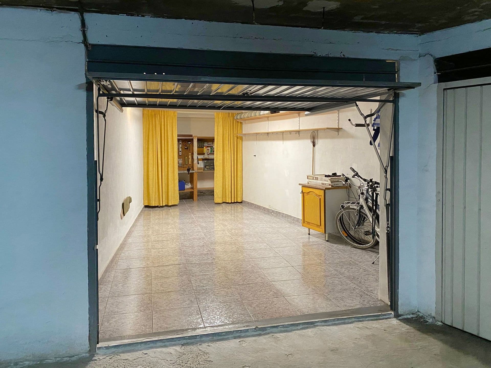 Spacious garage in the Eliseos Playa residential complex in Mar Azul, Torrevieja. The garage is completely private and in very good condition, with tiled flooring and lighting. Well-located within the garage, close to the entrance and with no water leaks. Shelves and a partition at the far end can be used for storage. This garage is one of the larger ones in the complex, so there is also space for items such as bicycles. It will be available for viewing in mid-May and completion as soon as possible thereafter.