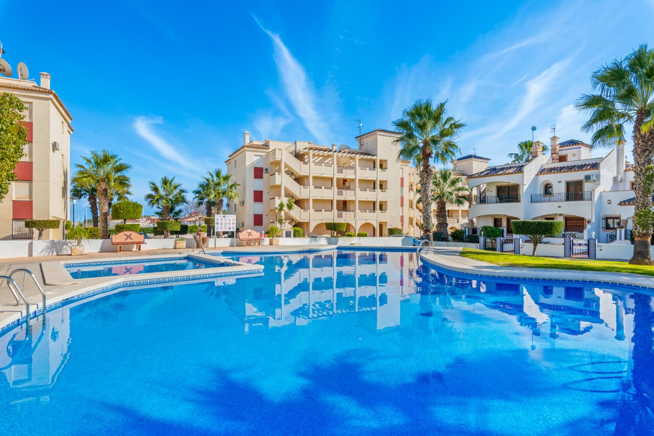 This spacious penthouse apartment is located within the sought after gated community of Jumilla III in Playa Flamenca, Orihuela Costa, Alicante. The apartment will be sold fully furnished and consists of a spacious living/dining room, a fully equipped kitchen, two double bedrooms with fitted wardrobes, two bathrooms (one is en-suite), air conditioning (hot/cold), and a generous balcony.Ideally positioned close to the popular La Florida area and nestled between Punta Prima and La Zenia, the property benefits from excellent access to beaches, shops, and everyday amenities.Jumilla III is a well kept development, featuring a large communal garden with swimming pool. The beaches of Playa Flamenca and Punta Prima are just five minutes away by car, La Zenia Boulevard is also a short drive away and offers free parking.Orihuela Costa enjoys year-round popularity thanks to its vibrant atmosphere, wide range of leisure facilities, and proximity to renowned golf courses including Campoamor, Las Ramblas, and Villamartín.