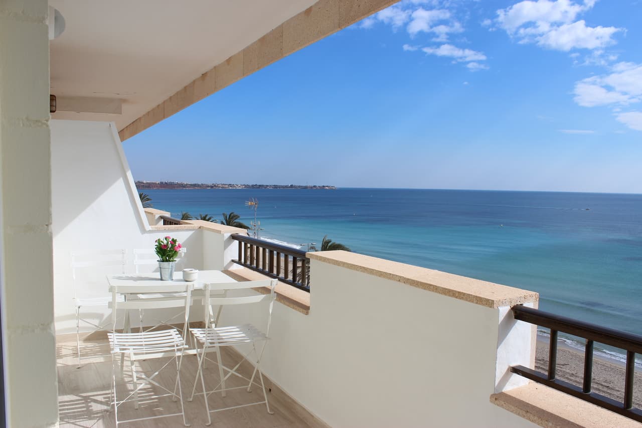 This frontline 3 bedroom second floor apartment (completely renovated in 2016) with frontal sea views is situated in Mil Palmeras, Alicante right in front of the beautiful long sandy Mil Palmeras beach. The apartment comes with a valid touristic license!The property will be sold fully furnished and consists of a bright living/dining room with direct access to the sunny terrace, a fully equipped open plan kitchen, three bedrooms with fitted wardrobes, two bathrooms (one is en-suite), air conditioning (hot/cold) throughout the property, shutters/blinds, two parking spaces (one parking space in the garage and one off road parking space on the plot)Surrounded by all local bars and restaurants, and frontline to the long sandy beaches. The building has a lift!Great rental potential.