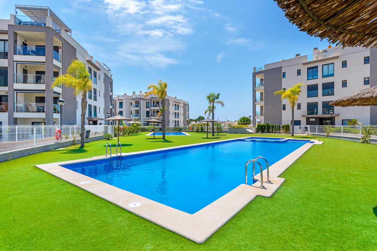 This immaculate modern second floor apartment with 2 bedrooms, 2 bathrooms is situated in Villamartin, Alicante only a few minutes walk to all local amenities (restaurants, bars and shops). The property will be sold fully furnished and comprises a spacious living/dining area, a modern open plan fully equipped kitchen, air conditioning (hot/cold) throughout the property, intercom system, a main bedroom with fitted wardrobes and en-suite bathroom, a further guests bedroom with fitted wardrobes, a second bathroom with walk-in shower. Patio doors lead out onto a private terrace with great views! There is also a private rooftop terrace/solarium to enjoy the Spanish weather all year long.Private allocated parking space in the garage is also included. There is a lovely communal green area with three communal swimming pools, children's playground area, tennis/padel court and a beautiful communal park. These apartments are fantastic value for money and the location is great with the bars, restaurants and amenities only a short walk away. The Villamartin area is very popular with tourists and most of the population consists of Western European expatriate communities who have settled there in the last 10 years, virtually transforming the village into a modern looking town. There are also other golf courses nearby and numerous white sandy beaches. The fantastic La Zenia beach and La Zenia Boulevard shopping centre is also a 10-minute drive. Villamartin Plaza and Villamartin golf are less than 4 minutes away.
