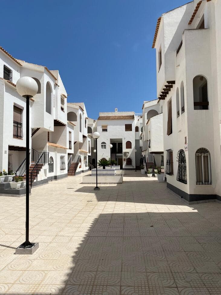 Excellent-condition apartment in the most Southern part of Torrevieja. Located on the first floor with West orientation. With 75 m² built, it features 3 spacious bedrooms, 2 full bathrooms, a fully equipped kitchen and a bright living room with terrace. Fully furnished, it includes double communal pool and green areas. Just 300 m from the sea and 500m from Playa De Los Naufragos, ideal for living or vacationing.This renovated apartment is located in a quiet and well-established residential area, surrounded by all services: supermarkets, restaurants, and shopping centers like La Zenia Boulevard are only a 10min drive away. Also known for its direct access to blue-flag beaches and coves, excellent connection to the N-332 and AP-7, and proximity to golf courses and sports areas. A privileged location to enjoy the Mediterranean climate all year round.
