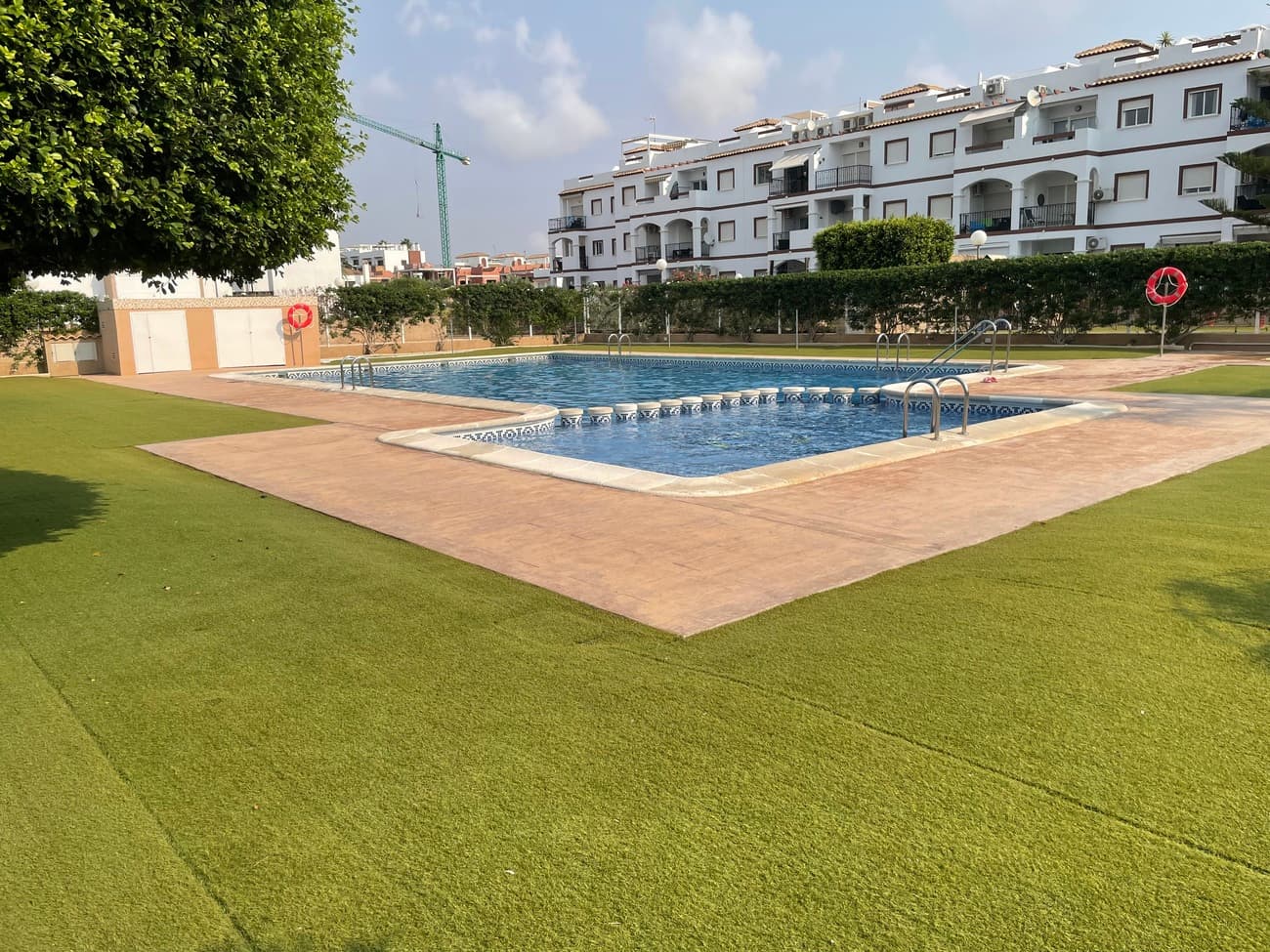 This well-maintained apartment offers an exceptional opportunity to enjoy coastal living just 900 meters from the Mediterranean in the popular area of Punta Prima, Orihuela Costa. Located on the second floor of a residential complex built in 2008, the property combines comfort, convenience, and investment potential.With a total built area of 65 m², the apartment features a bright and functional layout comprising:2 double bedrooms with built-in wardrobes2 full bathrooms, including one en-suiteOpen-plan living and dining area with natural light and direct access to a private balconyModern, fully equipped kitchenPrivate rooftop solarium with panoramic sea views ideal for sunbathing, dining, or relaxing outdoorsAdditional features include fully furnished interiors, and a private parking space within the community. Residents benefit from access to a communal swimming pool and a peaceful setting within a gated complex.The apartment is in excellent condition and ready to move into!Situated in a quiet yet central area, all essential amenities are within walking distance—including supermarkets, restaurants, pharmacies, and bus connections. The beach and the Zenia Boulevard shopping centre are also just minutes away.This property is ideal as a permanent residence, a holiday home, or a high-yield rental investment, offering a low-maintenance lifestyle with sea views in one of the most desirable areas of the Costa Blanca. Contact us today to book your viewing!