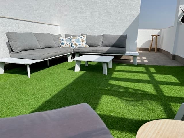 Sunny penthouse with breathtaking views over the salt lake – with spacious roof terrace and private parkingDiscover this charming and ready-to-move-in 1-bedroom penthouse, ideally located on the first line with unobstructed views of the enchanting salt lake. A unique opportunity, because this view is guaranteed to remain – there will be no further construction in front of the property!Located on the second floor, accessible by lift, this apartment offers every comfort and charm. Inside you will find a cosy living room with a clever built-in cupboard/bed, perfect for extra guests. The bedroom also has built-in cupboards, as do the outdoor areas – practical and stylish.The eye-catcher? The spacious 52 m² roof terrace with sun awning, where you can enjoy the sun and the panoramic view. The outdoor kitchen with practical storage cupboards completes the picture – ideal for relaxing evenings or cosy dinners with friends.Additional advantages:Air conditioning and heating for optimal comfort all year roundBuilt-in cupboard under the stairsPrivate underground parking space includedLift availableCommunal swimming poolThis apartment combines tranquillity, views and functionality in a unique location. Ideal as a permanent home, holiday home or investment.The commercial area of Oasis Centre already has at least one bar/pizzeria (originally a food truck); other units will be available soon and will have rooftop terraces overlooking the lagoon.Around the corner: shops, supermarkets, restaurants, bars and markets such as the weekly Lemon Tree Market on Sundays.Don't miss this opportunity – contact us today for a viewing!