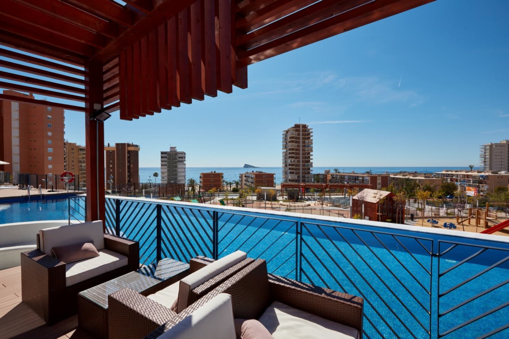 These exclusive three-bedroom apartments are located in the heart of Poniente Beach, in a building that stands out for the exceptional quality of each of its finishes.This spacious apartment, situated in a prestigious residential area, offers a unique experience that combines modern design, comfort, and sea views, making each stay special.The property features a comfortable and bright layout: a large living room with direct access to a spacious terrace, three bedrooms with double beds, two modern bathrooms, and an elegant open-plan kitchen fully equipped with high-quality appliances. Every detail is carefully considered, from the materials used to the diffused lighting that adds warmth and style to the home.The apartment includes a parking space and a storage room, adding functionality and convenience to everyday life.It offers its residents unparalleled amenities: over 13,000 m² of communal areas, which include several pools, jacuzzis, relaxation areas, sports courts, a gym with a sauna, a heated training pool, and areas for resting and reading.The ideal home for those seeking exclusivity, comfort, and a privileged location by the sea.