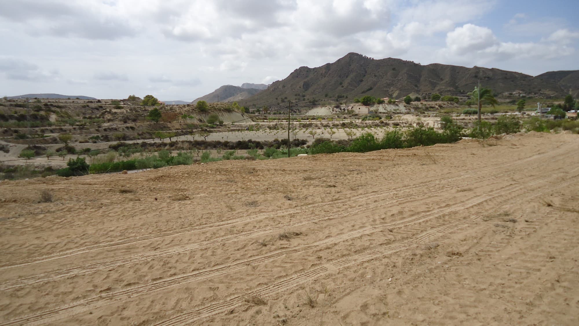 This 7,477 m² plot in Abanilla offers a peaceful setting with stunning views of the surrounding mountainous landscape. The land is suitable for building a 20 m² shelter with a 20 m² porch, or for installing a mobile home or caravan, providing flexibility for those looking to create a retreat or vacation spot. The plot includes olive trees and benefits from irrigation water, with the possibility of connecting to drinking water. Access is convenient, with a paved road leading up to just 150 meters from the property.The Area:Located near the charming towns of Mahoya and Abanilla, this plot combines rural tranquility with easy access to local amenities. Abanilla is known for its rich cultural heritage and natural beauty, with scenic views and hiking trails. The nearby town of Mahoya offers restaurants, shops, and essential services, making it a convenient location for both relaxation and daily needs. This property is ideal for those seeking a quiet retreat while staying connected to the local community.We have a large portfolio of properties in the Costa Blanca and Costa Calida areas, specialising in country properties, villas, fincas, building plots and design and build options in the Alicante and Murcia regions with a particular emphasis on Elda, Monovar, Pinoso, Sax, Villena, Aspe, Fortuna, Albacete and many more surrounding areas. We have been established since 2004 and have decades of experience between the team which we bring to bear to help you find and secure your new dream home. We help you every step of the way to make sure your purchase in Spain is safe and hassle free. We are not here to sell you a property, we are here to help you realise your dream and find what is right for you. With us you are in the safest hands. Contact us now to have a no obligation chat about how you too can realise your dreams.