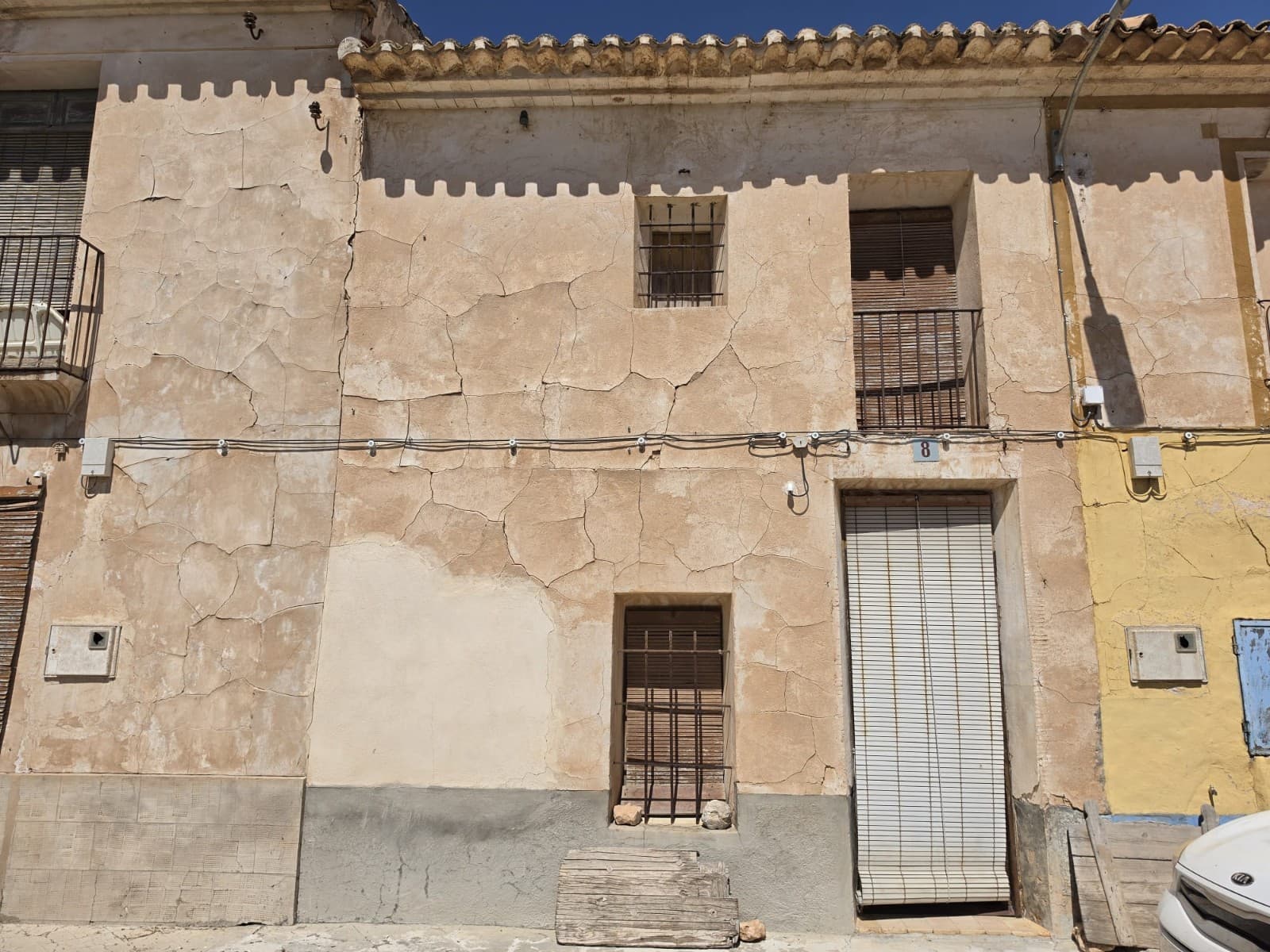 This large traditional townhouse is located in the peaceful village of La Canalosa, enjoying beautiful mountain views and the charm of authentic Spanish village life. Full of character and original features, the property offers an excellent opportunity for someone looking to restore and create a spacious family home, holiday property, or investment project.The main house has already benefited from new roofs, preserving its traditional style while providing a solid starting point for renovation. On the ground floor, the property includes an entrance hall, a bedroom, a large living room with a fireplace, two additional rooms, and a bathroom. Upstairs, there are five further rooms, offering the flexibility to create up to six or seven bedrooms depending on your needs and design preferences.Directly opposite the house is an additional plot included in the sale, featuring a small building currently used as a kitchen with a barbecue area, along with a piece of land behind it. Additionally it comes with an urban plot which is located just a few metres from the main property and offers an excellent opportunity for a variety of uses. Measuring approximately 280 m², the plot includes a small existing hut/storage building and benefits from its location within the village boundaries.The land could be used as a private garden, vegetable plot, parking area, outdoor leisure space, or potentially for future development, subject to the relevant planning permissions. Its convenient location close to the main house makes it an ideal addition for anyone looking to expand their outdoor space or investment potential.This is a property with plenty of space, character, and possibilities, ready to be transformed into something truly special.There is also the possibility to buy the house without the additional urban plot, see reference 61135aAbout the Area La Canalosa is a small and friendly village located between Hondón de las Nieves and Hondón de los Frailes, surrounded by vineyards, almond groves, and mountain scenery. The area is popular with those seeking a peaceful lifestyle while remaining close to everyday amenities. Nearby towns offer shops, restaurants, medical facilities, and local markets, while Alicante airport and the Costa Blanca beaches can be reached in around 40 minutes. It is an ideal location for anyone looking to enjoy the authentic Spanish countryside with excellent views and a welcoming community.We are specialists in the Costa Blanca and Costa Calida specialising in the Alicante and Murcia Inland regions with a particular emphasis on Elda, Pinoso, Aspe, Elche and surrounding areas. We are an established, well known and trusted company that has built a solid reputation amongst buyers and sellers since we began trading in 2004. We offer a complete service with no hidden charges or surprises, starting with sourcing the property, right through to completion, and an unrivalled after sales service which includes property management, building services, and general help and advice to make your new house a home. With a portfolio of well over 1400 properties for sale, we are confident that we can help, so just let us know your preferred property, budget and location, and we will do the rest.