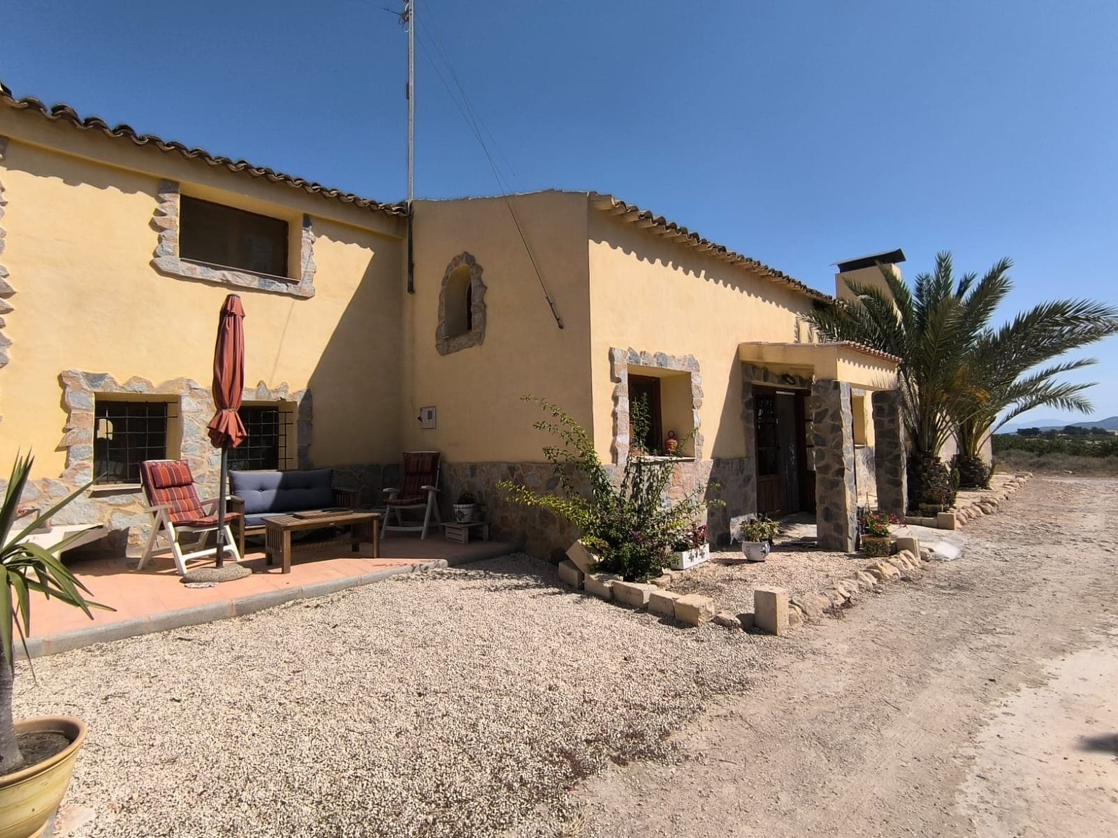 This spacious 4-bedroom, 2-bathroom villa in Chinorlet offers a great mix of completed renovations and room for personal customization. Half of the property has already been tastefully modernized, allowing new owners to finish the remaining spaces to suit their own style and needs. With a generous layout, multiple storage areas, and flexible room configurations, it's ideal for families, remote workers, or anyone seeking a peaceful escape.The home features a private swimming pool in a courtyard setting, a terrace with beautiful countryside views, a fireplace for cooler evenings, and ceiling fans for comfort in the warmer months. Mains water and electricity are connected, making it ready for immediate use and future updates.About the Area: Chinorlet is a small village located near Monóvar, in the province of Alicante. It's known for its quiet rural setting, traditional charm, and friendly community. The area is surrounded by vineyards, olive groves, and natural landscapes, ideal for hiking and enjoying outdoor life. Monóvar, just a short drive away, offers all essential services including supermarkets, schools, healthcare, and restaurants. Alicante city and the beaches of the Costa Blanca are within 45 minutes by car.We have a large portfolio of properties in the Costa Blanca and Costa Calida areas, specialising in country properties, villas, fincas, building plots and design and build options in the Alicante and Murcia regions with a particular emphasis on Elda, Monovar, Pinoso, Sax, Villena, Aspe, Fortuna, Albacete and many more surrounding areas. We have been established since 2004 and have decades of experience between the team which we bring to bear to help you find and secure your new dream home. We help you every step of the way to make sure your purchase in Spain is safe and hassle free. We are not here to sell you a property, we are here to help you realise your dream and find what is right for you. With us you are in the safest hands. Contact us now to have a no obligation chat about how you too can realise your dreams.