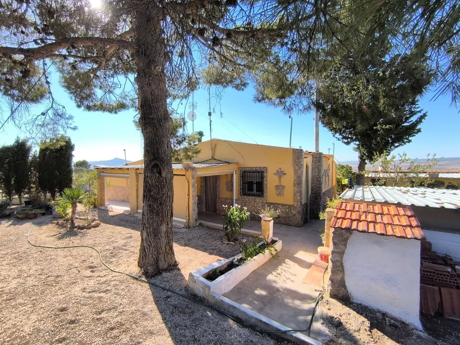 Ready to move in Villa in tranquil area with stunning viewsThis charming property offers comfortable living with 3 bedrooms, 2 bathrooms, fully equipped kitchen, a living room and an additional guest toilet. The home features a garage, which can be converted into another bedroom. Outside find a covered terrace, a car port, well-maintained garden with enough shade, perfect for gardening and other leisure activities, and a barbecue area, all set on a fully fenced 2,000 m² plot. Furthermore, there is an old pool, converted into a little workshop/storage, which could be turned back into a pool. The property has electricity, and irrigation water. With a good access via a short dirt road, and other houses in the further area, this home offers a perfect blend of comfort and laid-back country life. Hiking area starts just behind your backdoor!About the AreaLocated just 10 min drive from Yecla, this property enjoys the tranquility of the countryside while being close to the town's amenities. Yecla is renowned for its wine production, cultural heritage, and vibrant local markets. With excellent road connections, you'll have convenient access to shops, restaurants, schools, and healthcare services. This is a great opportunity to enjoy rural living without sacrificing convenience.We have a large portfolio of properties in the Costa Blanca and Costa Calida areas, specialising in country properties, villas, fincas, building plots and design and build options in the Alicante and Murcia regions with a particular emphasis on Elda, Monovar, Pinoso, Sax, Villena, Aspe, Fortuna, Albacete and many more surrounding areas. We have been established since 2004 and have decades of experience between the team which we bring to bear to help you find and secure your new dream home. We help you every step of the way to make sure your purchase in Spain is safe and hassle free. We are not here to sell you a property, we are here to help you realise your dream and find what is right for you. With us you are in the safest hands. Contact us now to have a no obligation chat about how you too can realise your dreams.