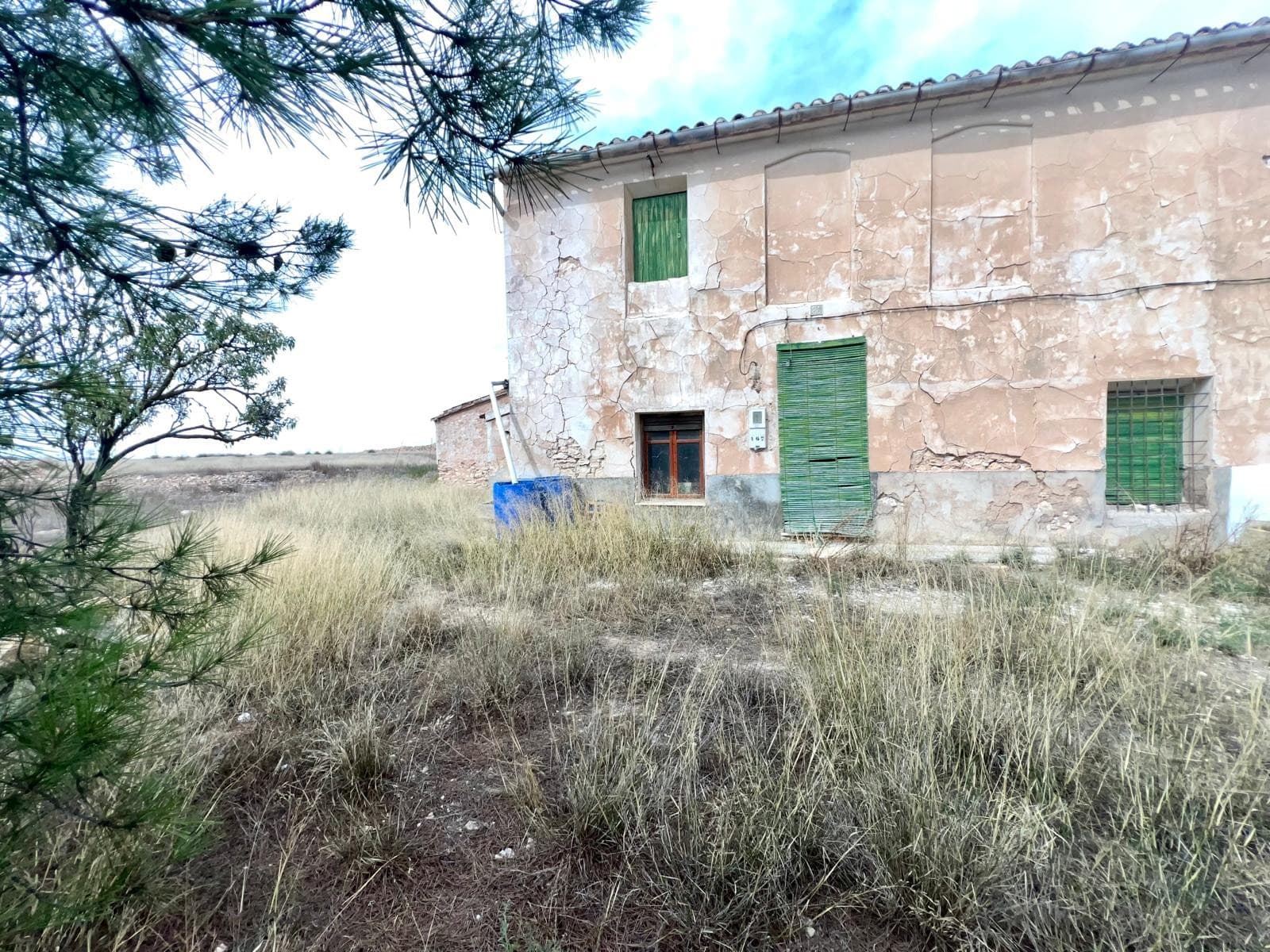 Nestled in the peaceful hamlet of Cañada del Trigo, this semi-detached country home offers a wonderful opportunity to create the rural retreat of your dreams. The property comes with two adjoining plots, one of 960 m² and another of 2,853 m², providing plenty of space for gardens, orchards, or even a private pool. The house itself sits beside a 70 m² courtyard and includes a 50 m² garage, ideal for parking, storage, or future workshop space.Inside, the home is full of character and natural light. On the ground floor, you'll find three bright bedrooms, a cozy living room with a traditional fireplace, and a large kitchen area that can easily be transformed into a spacious modern kitchen-diner opening onto the patio. There's also a small storage room, perfect for keeping everyday essentials organized. The upper floor is as large as the ground floor, offering ample additional space that can be converted into more bedrooms, a studio, or a guest area, allowing you to tailor the home entirely to your lifestyle.While the property is in need of renovation, it offers excellent potential to design and refurbish it entirely to your taste , whether you're dreaming of a rustic countryside getaway or a comfortable family home.Cañada del Trigo is a quiet and welcoming village, surrounded by vineyards, almond groves, and rolling hills. It's the perfect place to enjoy the tranquility of the countryside without feeling isolated. The hamlet lies just 10 minutes from the vibrant town of Pinoso and about 20 minutes from Jumilla, both known for their excellent local wines, traditional markets, and Mediterranean charm.The nearby town of Pinoso offers all essential amenities, supermarkets, restaurants, schools, and medical services, while maintaining the charm of authentic Spanish life. With its friendly community, excellent cuisine, and cultural festivals throughout the year, Pinoso makes the perfect complement to your serene country living in Cañada del Trigo.If you liked this property, do not hesitate to contact us to organize a visit, we will be happy to help you!We have a large portfolio of properties in the Costa Blanca and Costa Calida areas, specialising in country properties, villas, fincas, building plots and design and build options in the Alicante and Murcia regions with a particular emphasis on Elda, Monovar, Pinoso, Sax, Villena, Aspe, Fortuna, Albacete and many more surrounding areas. We have been established since 2004 and have decades of experience between the team which we bring to bear to help you find and secure your new dream home. We help you every step of the way to make sure your purchase in Spain is safe and hassle free. We are not here to sell you a property, we are here to help you realise your dream and find what is right for you. With us you are in the safest hands. Contact us now to have a no obligation chat about how you too can realise your dreams.
