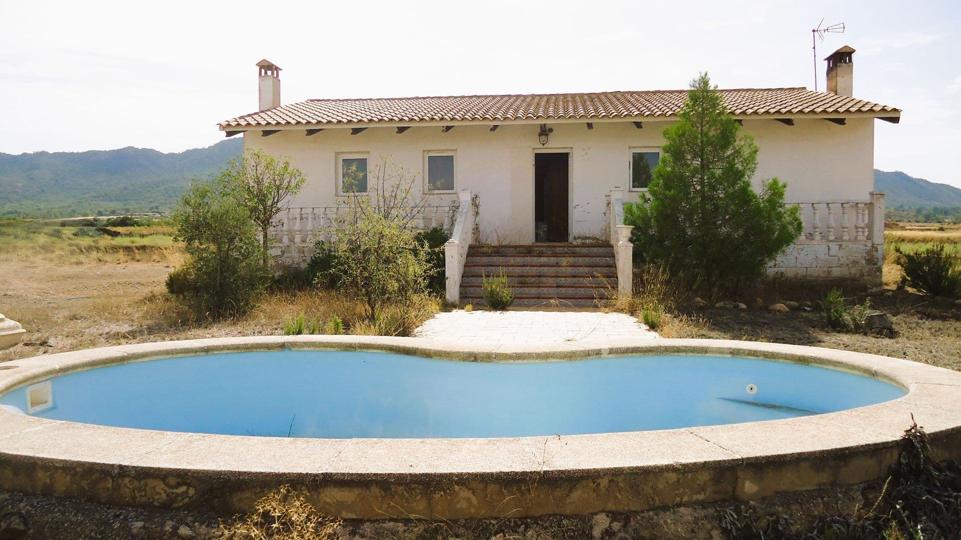 Enjoy peace, space and nature in this lovely detached country home located in a beautiful countryside, about 15 min from the lively town of Yecla. The house has 127 m² built on a 3,618 m² plot, offering plenty of room to relax and enjoy outdoor living. Inside, it features 3 bedrooms (one with en-suite bathroom), a second, shared bathroom, a bright and welcoming living room with fireplace, and a fully equipped kitchen with an indoor wood-burning barbecue — perfect for family meals and cosy evenings.Outside, you'll find a large swimming pool and green area surrounded by open countryside views. The property needs some love and care, but is in good structural condition, including the floors and the roof, constructed upon a suspended ground floor slab. Furthermore, the house is equipped with solar panels and batteries, and has an irrigation water connection, making it ideal choice for sustainable, eco-friendly living.About the area: Yecla is a charming and historic town of app. 35000 inhabitants, located in the region of Murcia. It is renowned for its award-winning wines, historical landmarks, and vibrant local culture. The surrounding natural landscapes of scenic mountains, vineyards and almond groves provide opportunities for outdoor activities, while the town itself offers all necessary services, including hospital, schools, shops, restaurants, and other services. With a friendly local community, lively markets, excellent gastronomy, and easy access to nature, Yecla is an ideal location for those seeking authentic Spanish lifestyle - just about an hour from the coast and Alicante airport.About us: We have a large portfolio of properties in the Costa Blanca and Costa Calida areas, specialising in country properties, villas, fincas, building plots and design and build options in the Alicante and Murcia regions with a particular emphasis on Yecla, Novelda, Elda, Monovar, Pinoso, Sax, Villena, Aspe, Fortuna, Jumilla, Abanilla, and many more surrounding areas. We have been established since 2004 and have decades of experience between the team which we bring to bear to help you find and secure your new dream home. We help you every step of the way to make sure your purchase in Spain is safe and hassle free. We are not here to sell you a property, we are here to help you realise your dream and find what is right for you. With us you are in the safest hands. Contact us now to have a no obligation chat about how you too can realise your dreams.