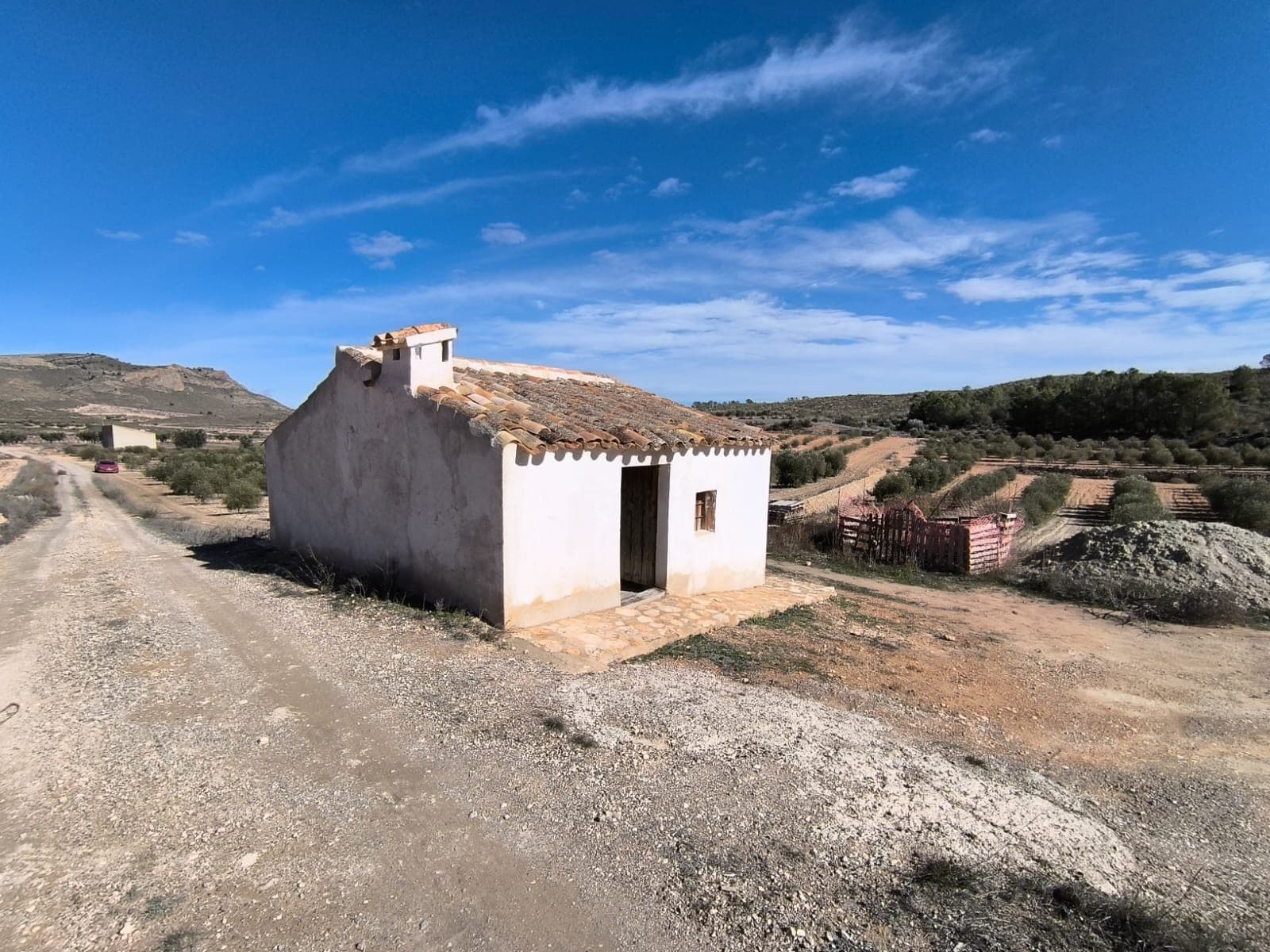 Newly restored chalet with 30,000 m² plot of land located in the rural area of Jumilla, just a 5-minute drive from the town. The property is easily accessible via a short dirt road and is situated in a tranquil and picturesque setting, surrounded by a few houses in the neighbourhood. For a better idea, take a look at the video we have made.On the land, there is a restored little house measuring 30m², with 3 empty rooms. While it is not currently connected to electricity, the grid is available at the edge of the parcel. Additionally, the property features a well that could be restored for water consumption.This parcel is potentially buildable and includes an orchard of healthy olive trees, yielding an average production of 6 tons of olives per year. The combination of olive production, a great location, and a low price makes this an excellent opportunity for investment or the construction of a dream home.About the area: Jumilla is a charming town renowned for its scenic vineyards, and vibrant local culture. Known primarily for its award-winning wines, this picturesque town offers a perfect blend of traditional Spanish character and modern living. With its historic landmarks, bustling market squares, and beautiful countryside, Jumilla provides an ideal setting for those seeking a peaceful yet vibrant lifestyle in province Murcia, 80 minutes from Costa Blanca.About us: We have a large portfolio of properties in the Costa Blanca and Costa Calida areas, specialising in country properties, villas, fincas, building plots and design and build options in the Alicante and Murcia regions with a particular emphasis on Elda, Monovar, Pinoso, Sax, Villena, Aspe, Fortuna, Albacete and many more surrounding areas. We have been established since 2004 and have decades of experience between the team which we bring to bear to help you find and secure your new dream home. We help you every step of the way to make sure your purchase in Spain is safe and hassle free. We are not here to sell you a property, we are here to help you realise your dream and find what is right for you. With us you are in the safest hands. Contact us now to have a no obligation chat about how you too can realise your dreams.