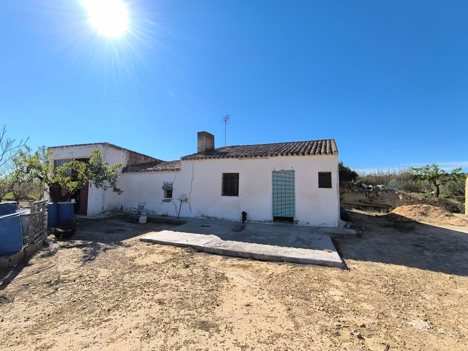 Are you looking for an affordable, non-negotiable privacy and tranquility? Set in a privileged natural landscape with panoramic views, this detached country house offers peace, space and an authentic rural atmosphere, 15 km from Yecla. Access to the property is convenient, with an asphalted road leading directly to the estate.The 22,000 m², partially fenced plot is planted with 250 productive olive trees and different fruit trees, granting your own agricultural production. It is an exceptional setting for nature lovers and especially suitable for dogs and horses, thanks to its generous open land and tranquil surroundings with no close neighbours.The 62 m² house includes 3 bedrooms and a living-dining room with a fireplace, creating a warm and functional living area. The property also features two agricultural buildings—one of 30 m² and another of 45 m²—providing versatile space for storage, workshops, animals or agricultural use.Please note that the estate does not have electricity connection or irrigation/potable water, making it ideal for off-grid living solutions. Only the dominio útil is transferred, granting the right to use and enjoy the land, buildings and existing plantations.A unique opportunity for those seeking natural beauty, privacy and large land in an exceptional rural environment.About the area: Yecla is a charming and historic town of app. 35000 inhabitants, located in the region of Murcia. It is renowned for its award-winning wines, historical landmarks, and vibrant local culture. The surrounding natural landscapes of scenic mountains, vineyards and almond groves provide opportunities for outdoor activities, while the town itself offers all necessary services, including hospital, schools, shops, restaurants, and other services. With a friendly local community, lively markets, excellent gastronomy, and easy access to nature, Yecla is an ideal location for those seeking authentic Spanish lifestyle - just about an hour from the coast and Alicante airport.About us: We have a large portfolio of properties in the Costa Blanca and Costa Calida areas, specialising in country properties, villas, fincas, building plots and design and build options in the Alicante and Murcia regions with a particular emphasis on Yecla, Novelda, Elda, Monovar, Pinoso, Sax, Villena, Aspe, Fortuna, Jumilla, Abanilla, and many more surrounding areas. We have been established since 2004 and have decades of experience between the team which we bring to bear to help you find and secure your new dream home. We help you every step of the way to make sure your purchase in Spain is safe and hassle free. We are not here to sell you a property, we are here to help you realise your dream and find what is right for you. With us you are in the safest hands. Contact us now to have a no obligation chat about how you too can realise your dreams.