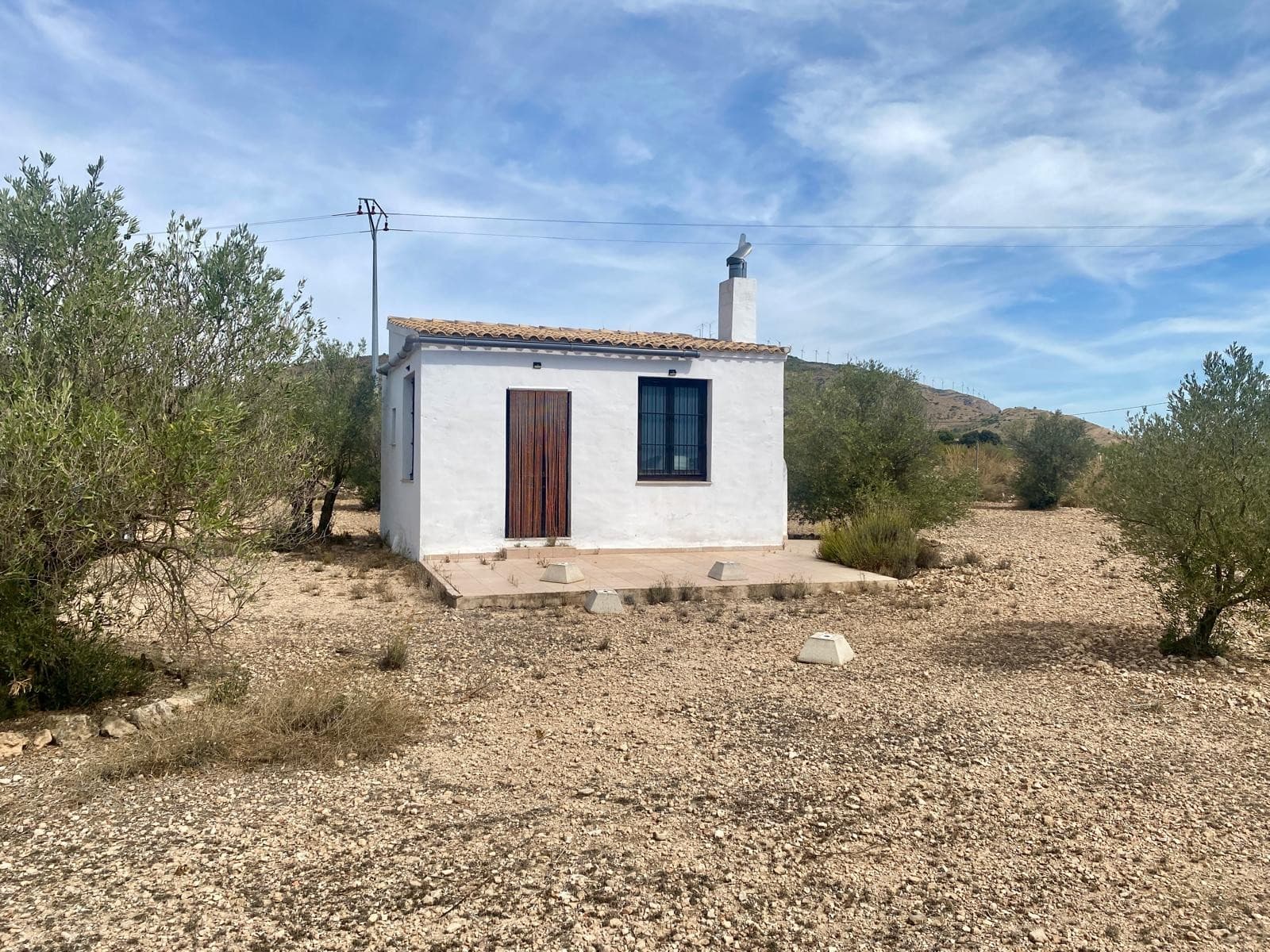 Small country house of 40 m2 for sale in a countryside area of Caudete. The property features a plot of 6000 m2 (of which roughly 2000 m2 are fenced), planted with 80 mature olive trees in production. The building is legal, officially registered as an agricultural warehouse/shed. It has a solid walls and roof, heated by a stove, there's room for 1 room and 1 bathroom. Water and electricity are not connected, but are available in the area.Located in a tranquil, rural area, this property offers a calm retreat for extensive gardening, or simply relaxing out of the town. Near mountain range of Sierra de la Oliva with its ample hiking opportunities and Via Ferratas is less than 2 km away. The property is 5 km from Caudete and its daily amenities.Don't hesitate to contact us for a viewing!About the area: Caudete is a charming and peaceful town of 10.000 inhabitants in the province of Albacete, known for its traditional Spanish character and welcoming community. Ideally located, it offers excellent road connections and is just 50 minutes from the beaches of the Costa Blanca and Alicante International Airport. The proximity of mountains offers ample hiking opportunities and splendid views. The town, which has all the daily amenities (shops, health centre, farmer's market, local services) provides easy access to major cities such as Alicante, Murcia, and Valencia, making it a perfect location for those seeking a tranquil lifestyle with the convenience of nearby urban centers and coastal escapes.About us: We have a large portfolio of properties in the Costa Blanca and Costa Calida areas, specialising in country properties, villas, fincas, building plots and design and build options in the Alicante and Murcia regions with a particular emphasis on Elda, Monovar, Pinoso, Sax, Villena, Aspe, Fortuna, Albacete and many more surrounding areas. We have been established since 2004 and have decades of experience between the team which we bring to bear to help you find and secure your new dream home. We help you every step of the way to make sure your purchase in Spain is safe and hassle free. We are not here to sell you a property, we are here to help you realise your dream and find what is right for you. With us you are in the safest hands. Contact us now to have a no obligation chat about how you too can realise your dreams.